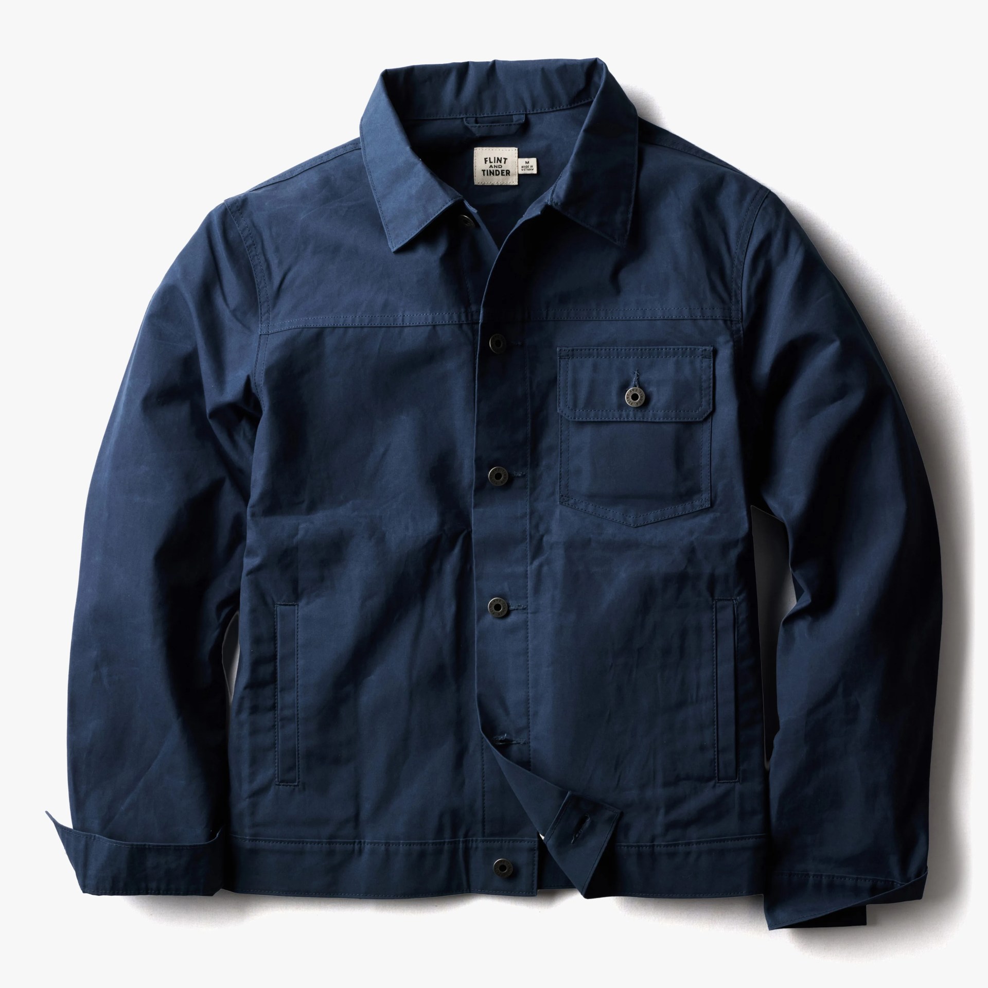 Navy blue button-up jacket with a chest pocket and two side pockets laid flat on a white background.