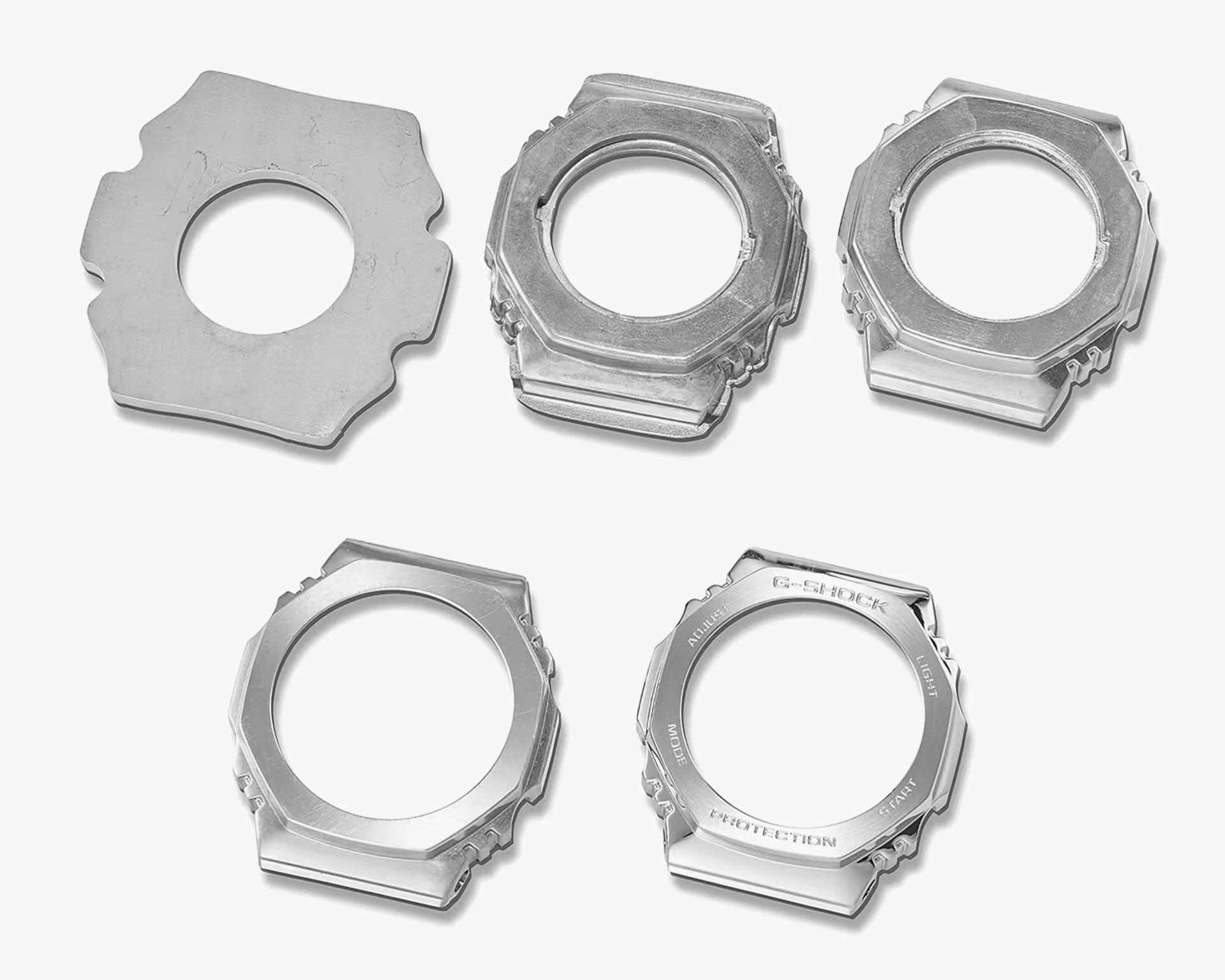 Five silver metal watch bezels with octagonal shapes arranged on a white background.