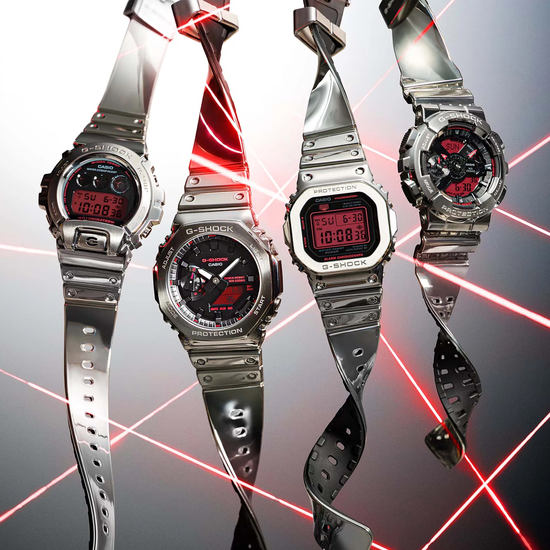 Four silver Casio G-Shock watches with red digital and analog displays, suspended with twisted metal straps and red laser beams.