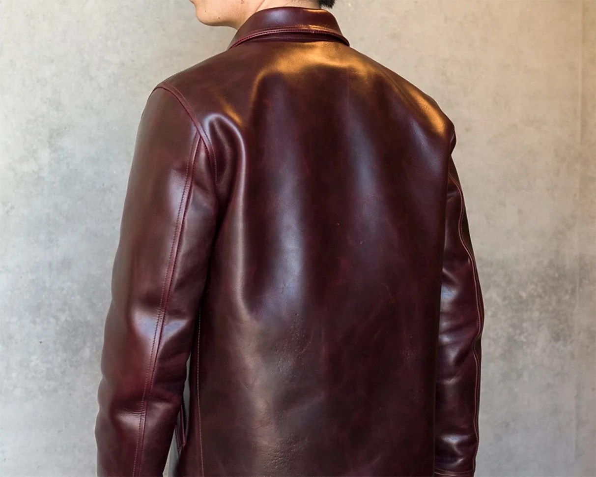 Dark brown leather jacket with a smooth finish shown from the back.