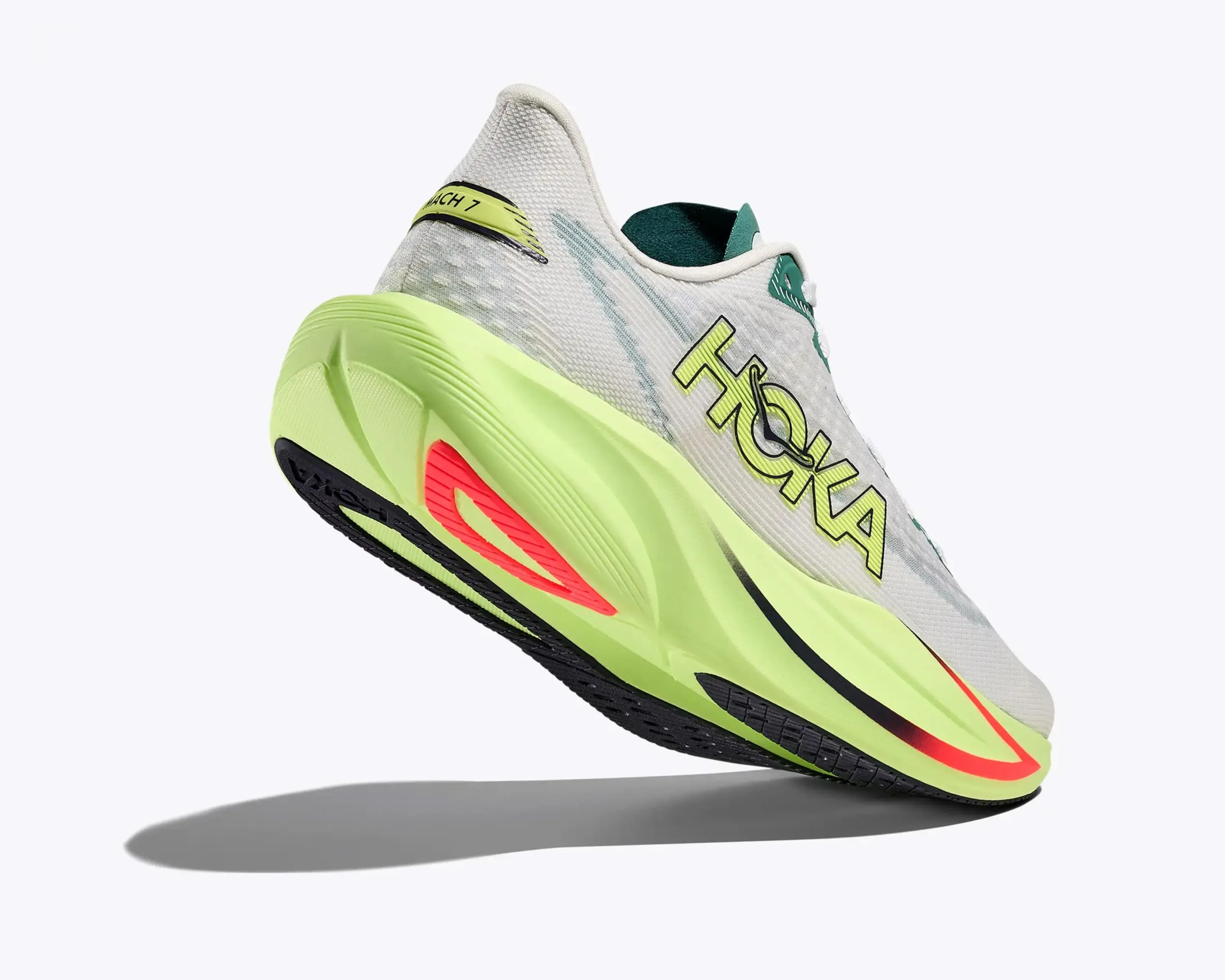 White and neon green Hoka running shoe with black and red sole accents, shown from a low rear angle.