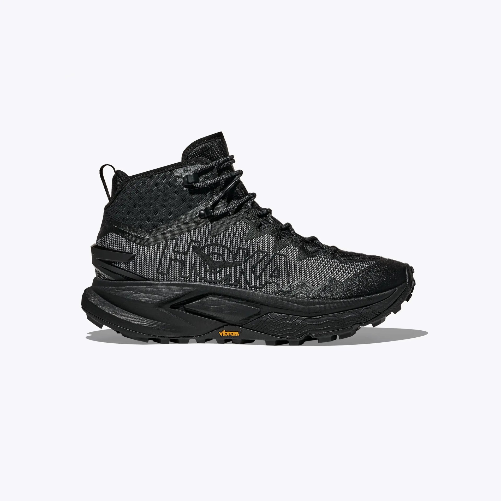 Black high-top Hoka trail running shoe with mesh upper and Vibram sole.