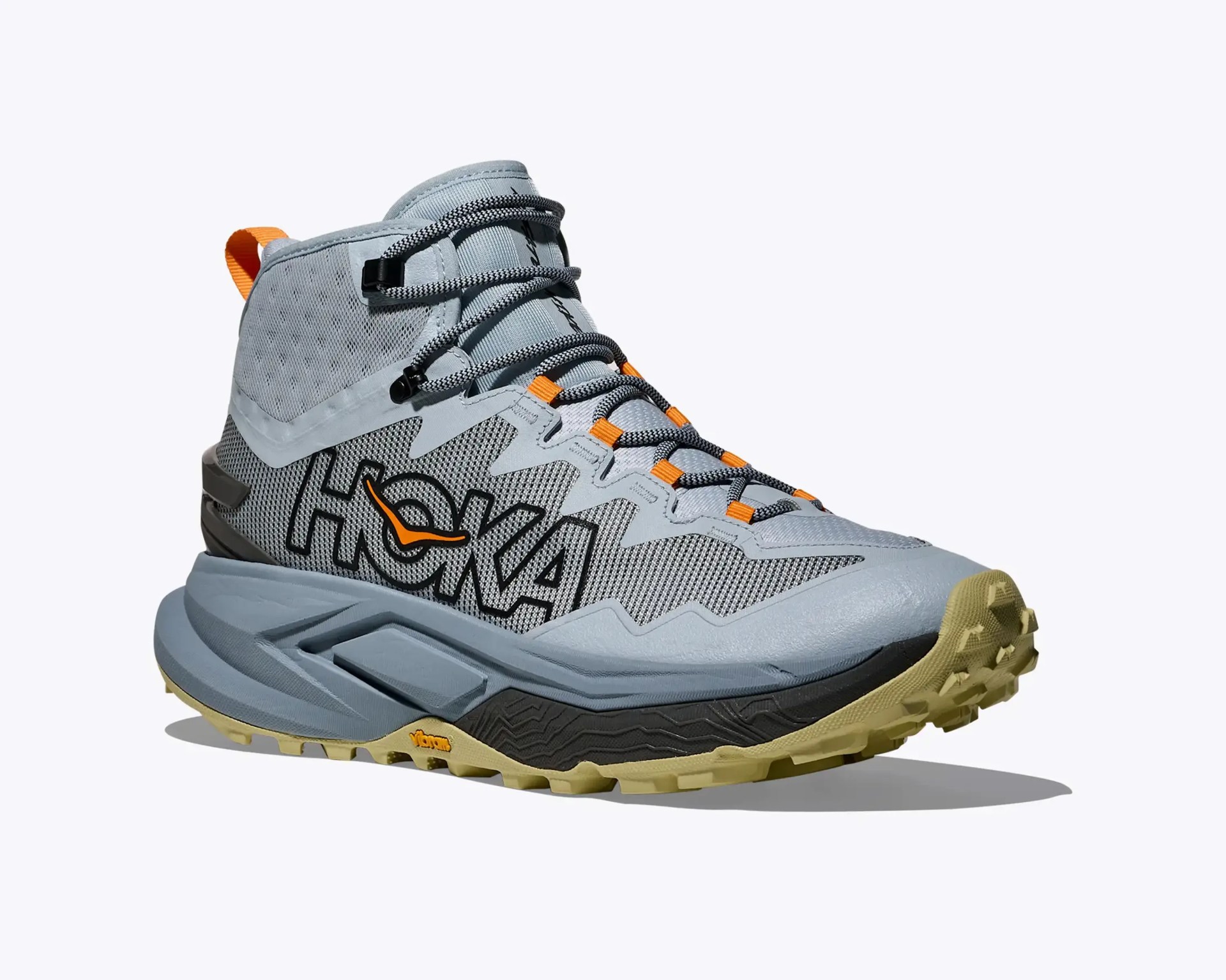 Gray and black Hoka hiking shoe with orange accents and a rugged beige Vibram sole.