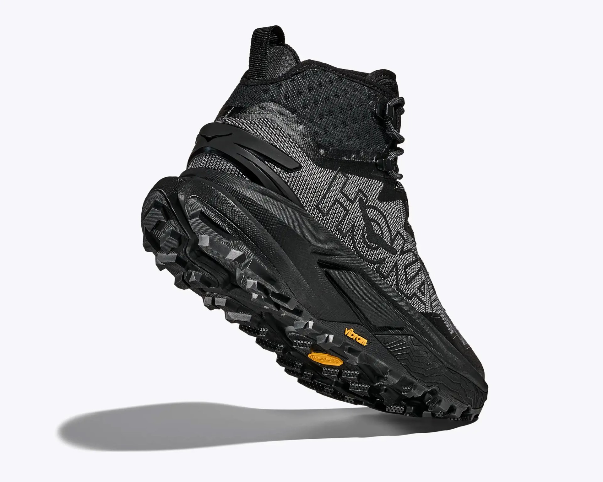 Black and gray Hoka hiking boot with Vibram sole and high ankle support.