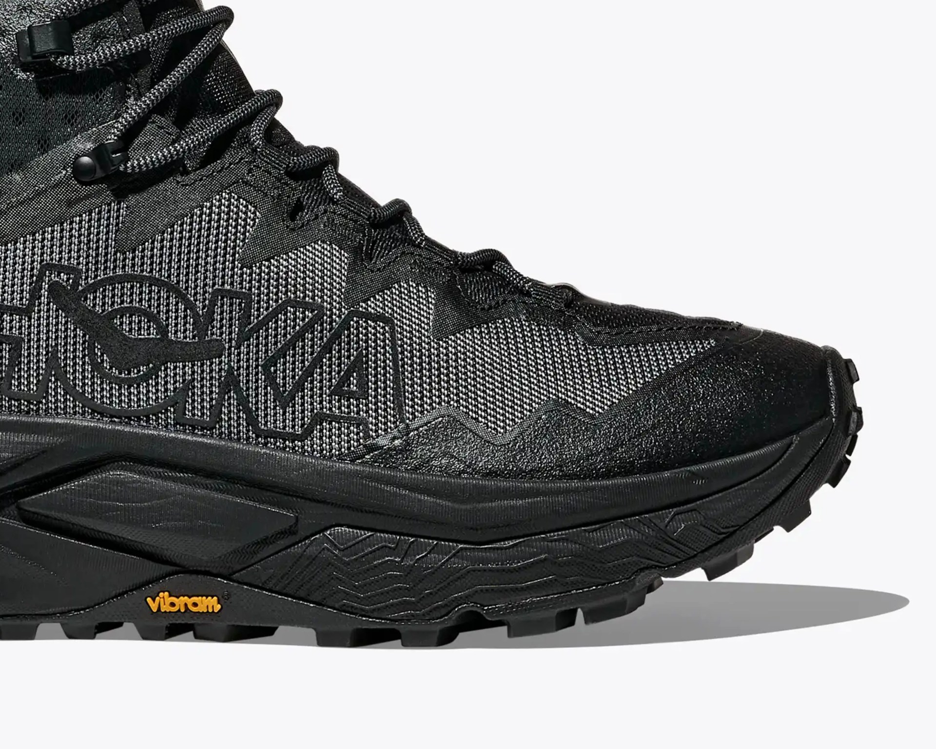 Black and gray Hoka trail running shoe with Vibram sole and large logo on the side.