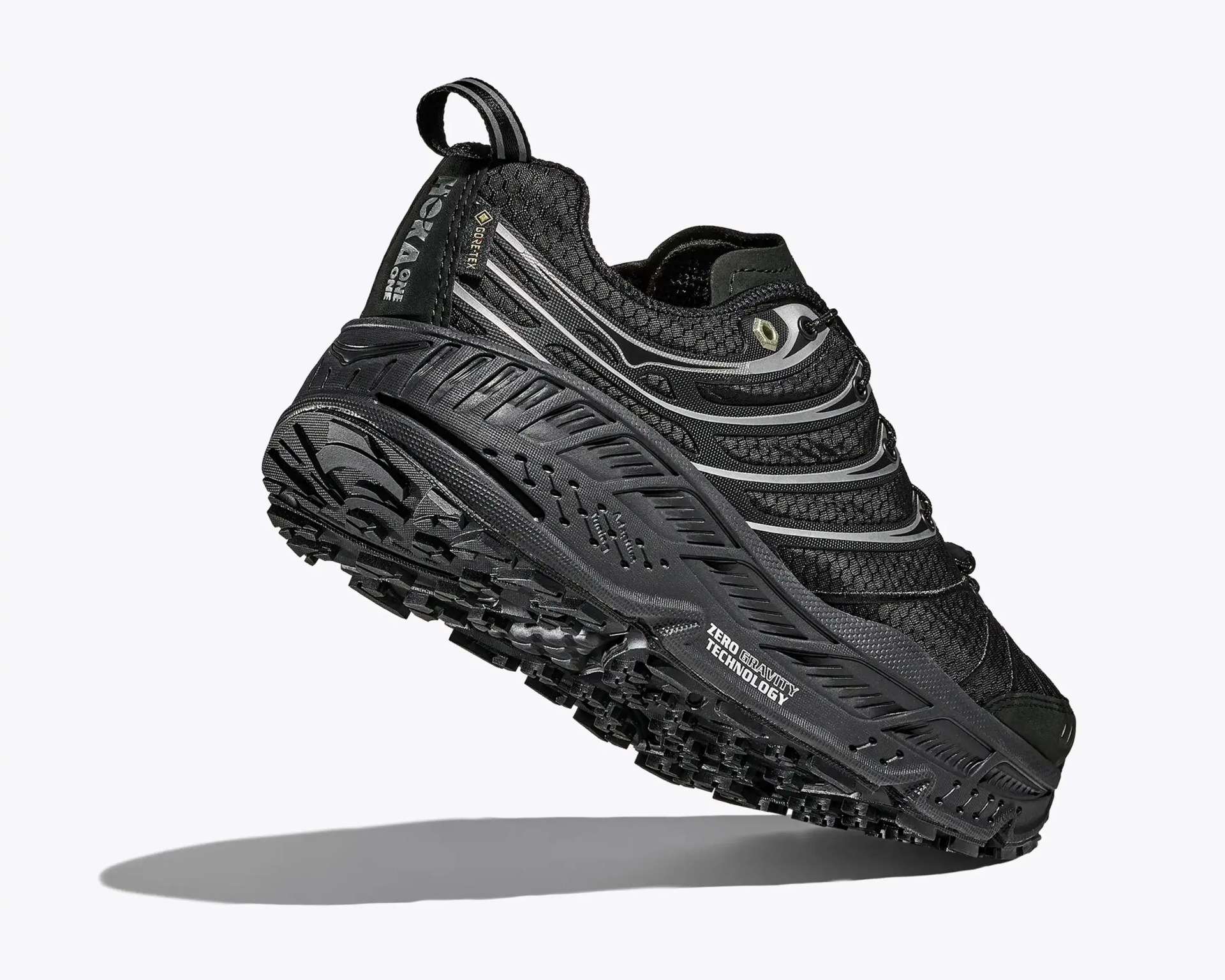 Black trail running shoe with textured mesh upper, thick rugged sole, and "Zero Gravity Technology" text on the side.
