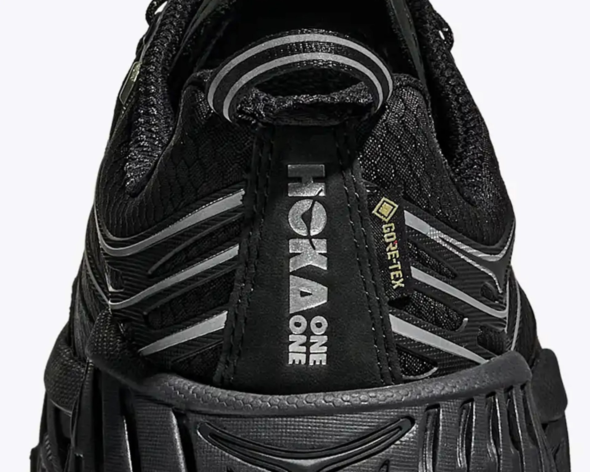 Close-up of the black Hoka One One shoe heel with Gore-Tex tag and reflective silver accents.