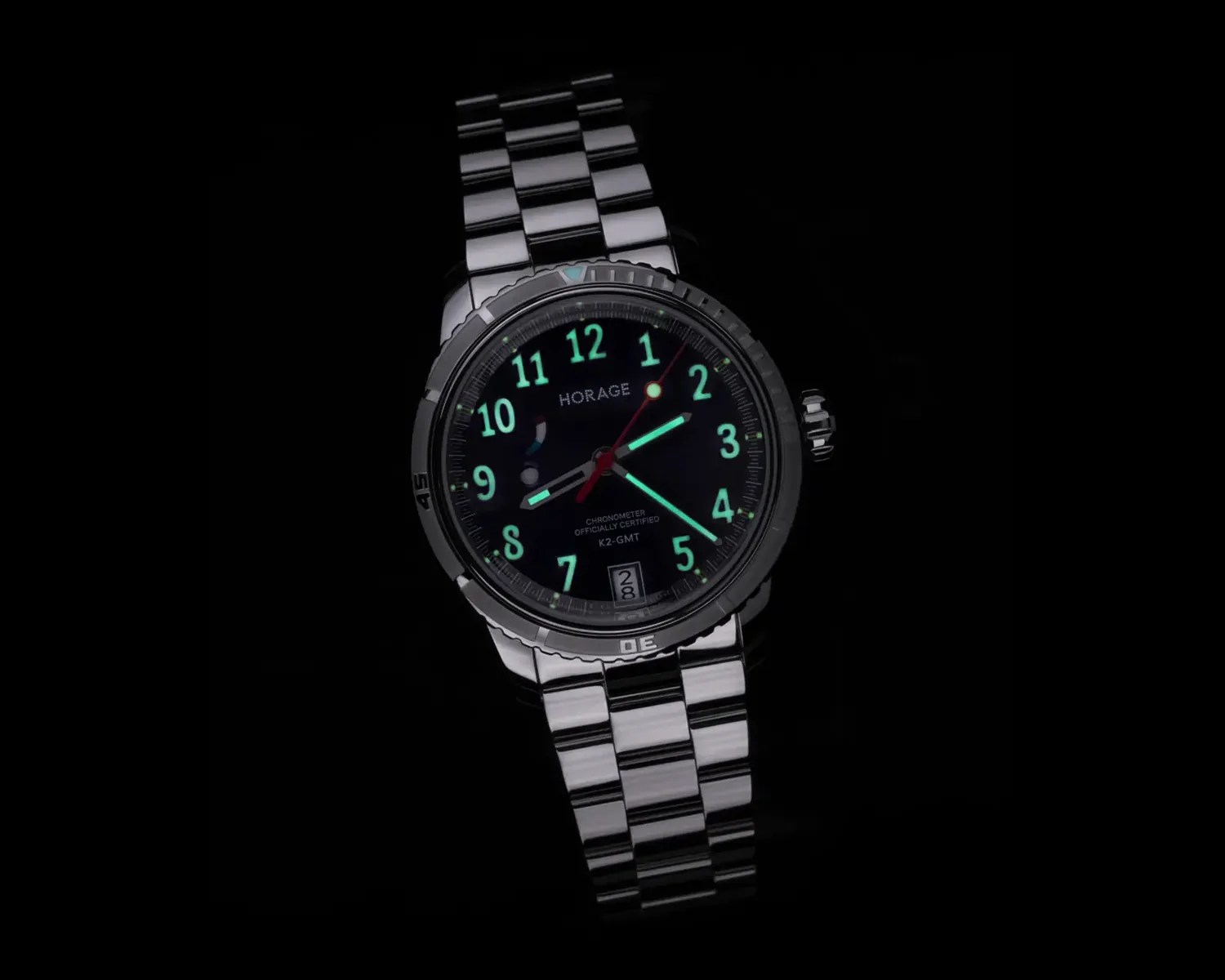 Stainless steel Horage watch with luminous green numerals and hands on a black dial.