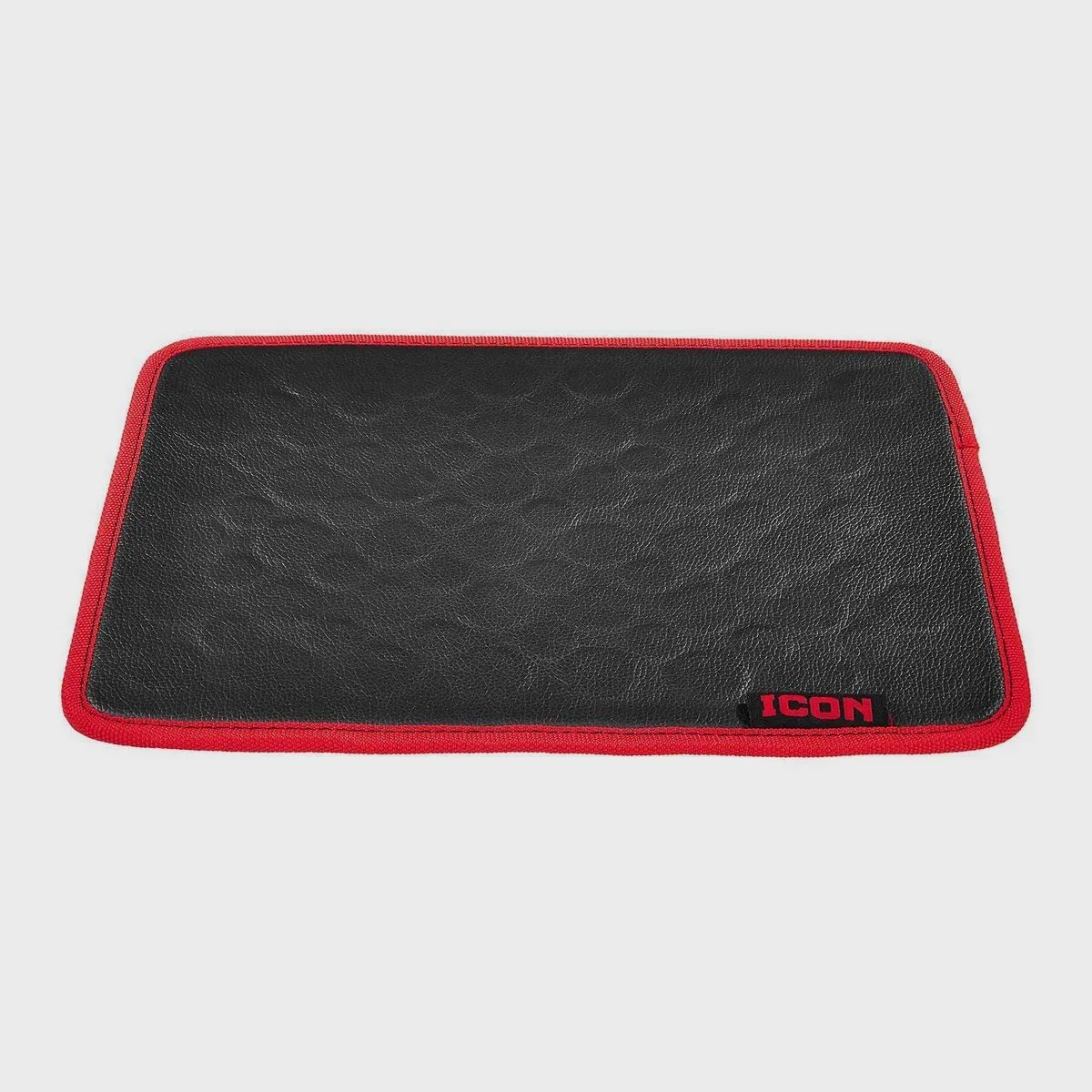 Black rectangular leather patch with red fabric border and a small "ICON" label in red and black on one corner.