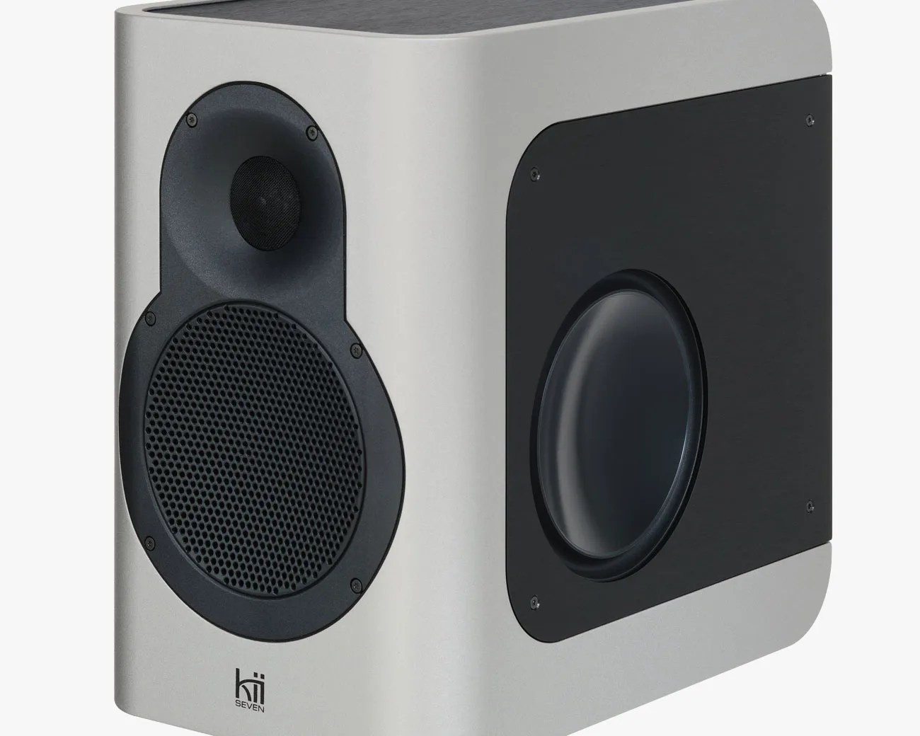 Compact silver and black Kii Seven speaker with front and side drivers and rounded edges.