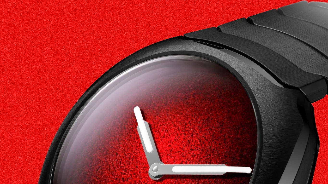 Black metal wristwatch with a textured red dial and white hour and minute hands.