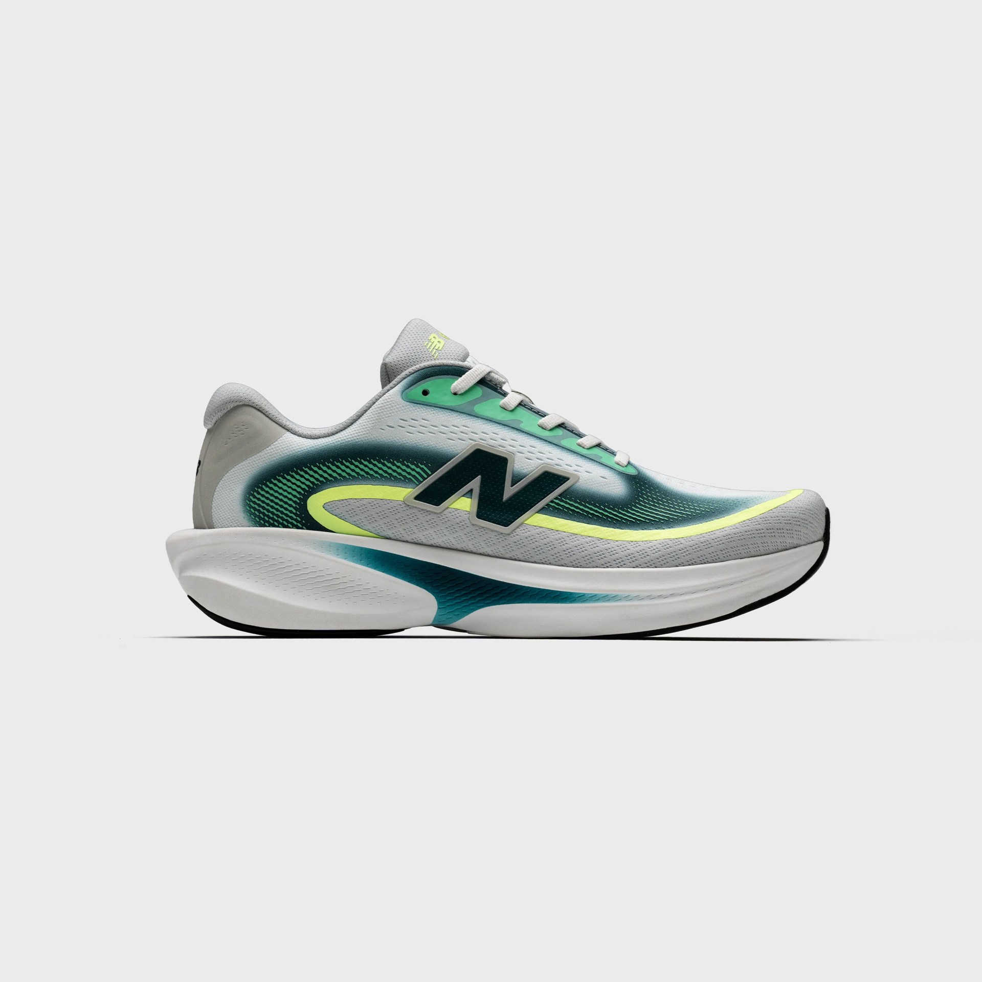 Light gray New Balance running shoe with teal and neon yellow accents and thick white sole.