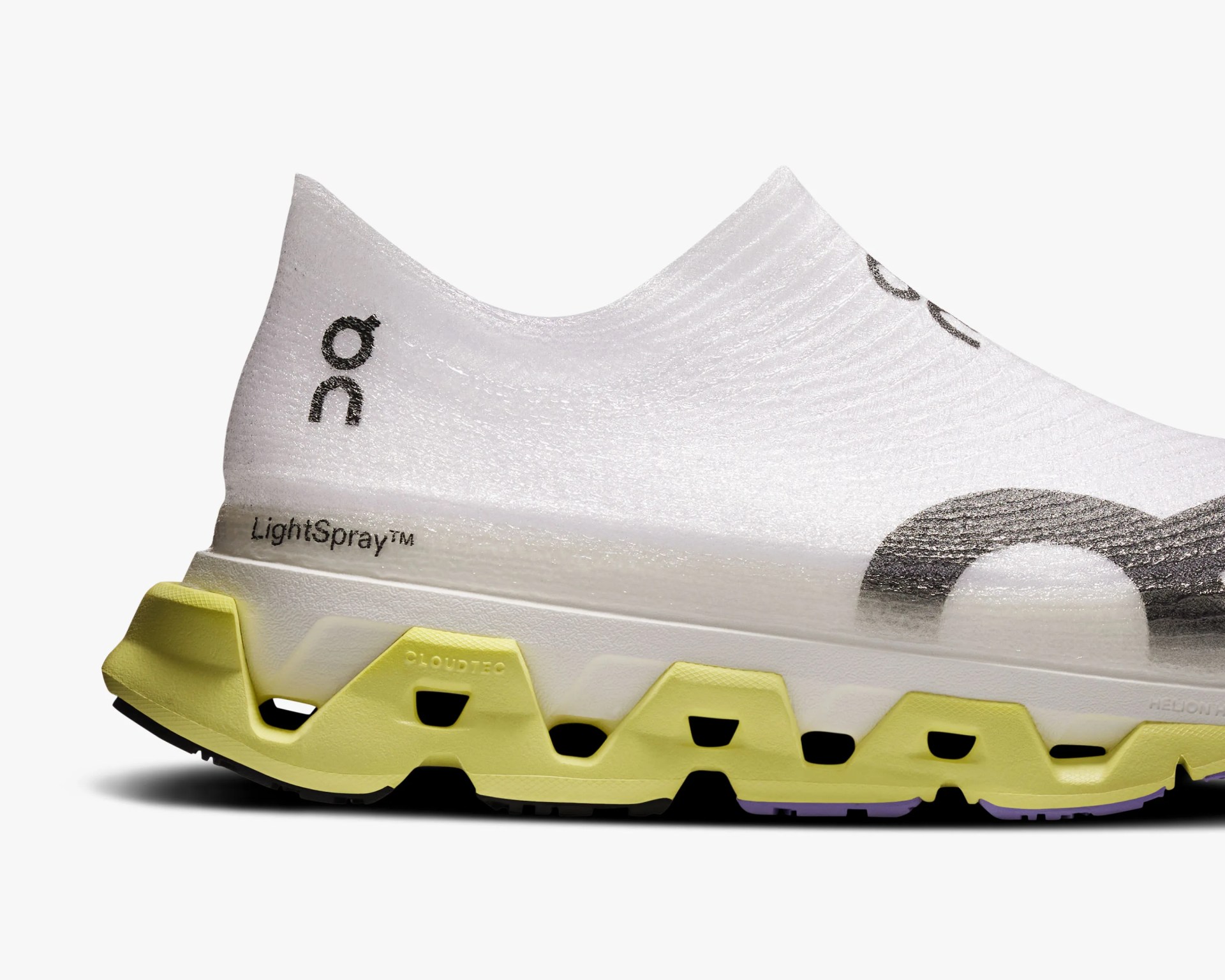 White slip-on athletic shoe with black logo, yellow sole with cutouts, and "LightSpray" text on the heel.