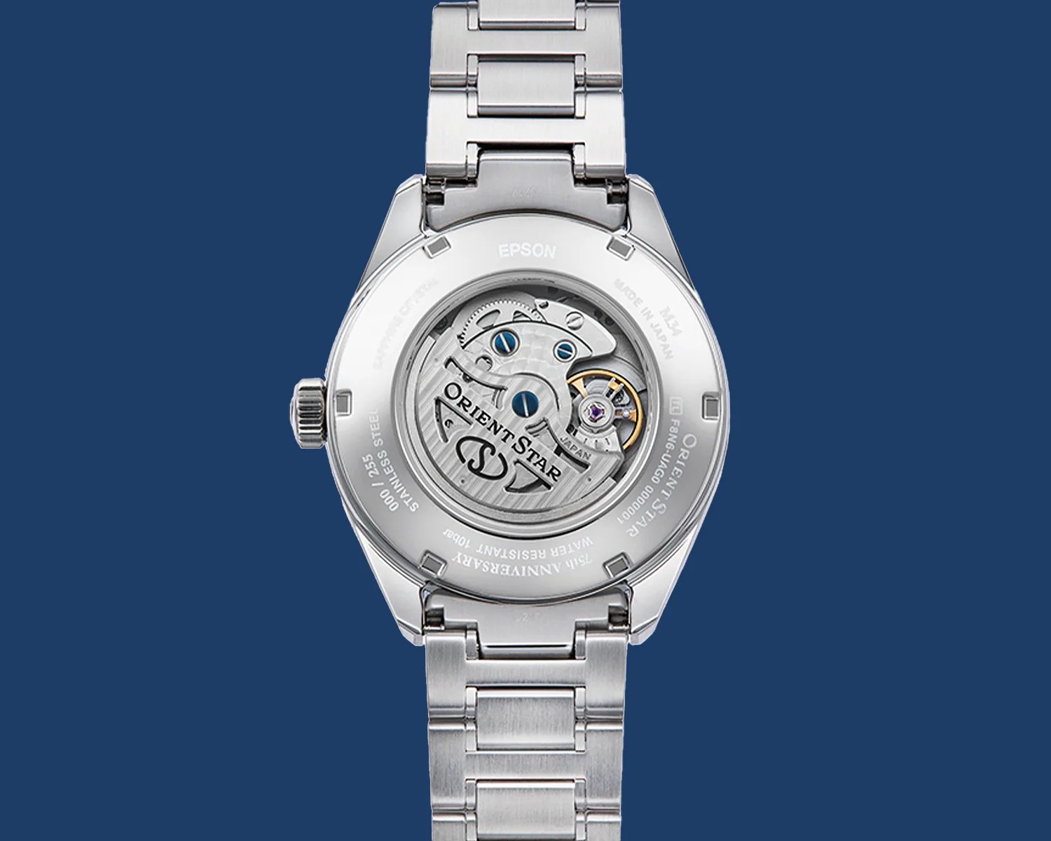 Back view of a silver stainless steel Orient Star wristwatch showing the mechanical movement through a transparent case back.