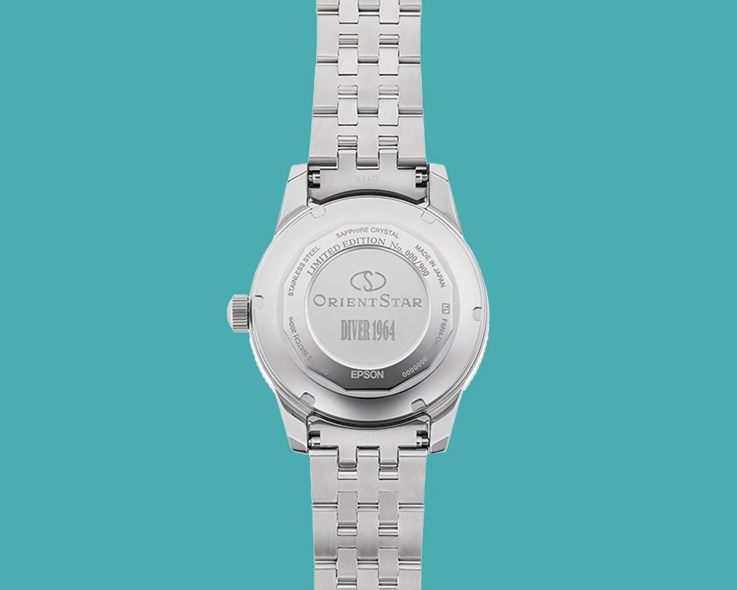 Back of a stainless steel Orient Star Diver 1964 limited edition watch with metal bracelet on teal background.