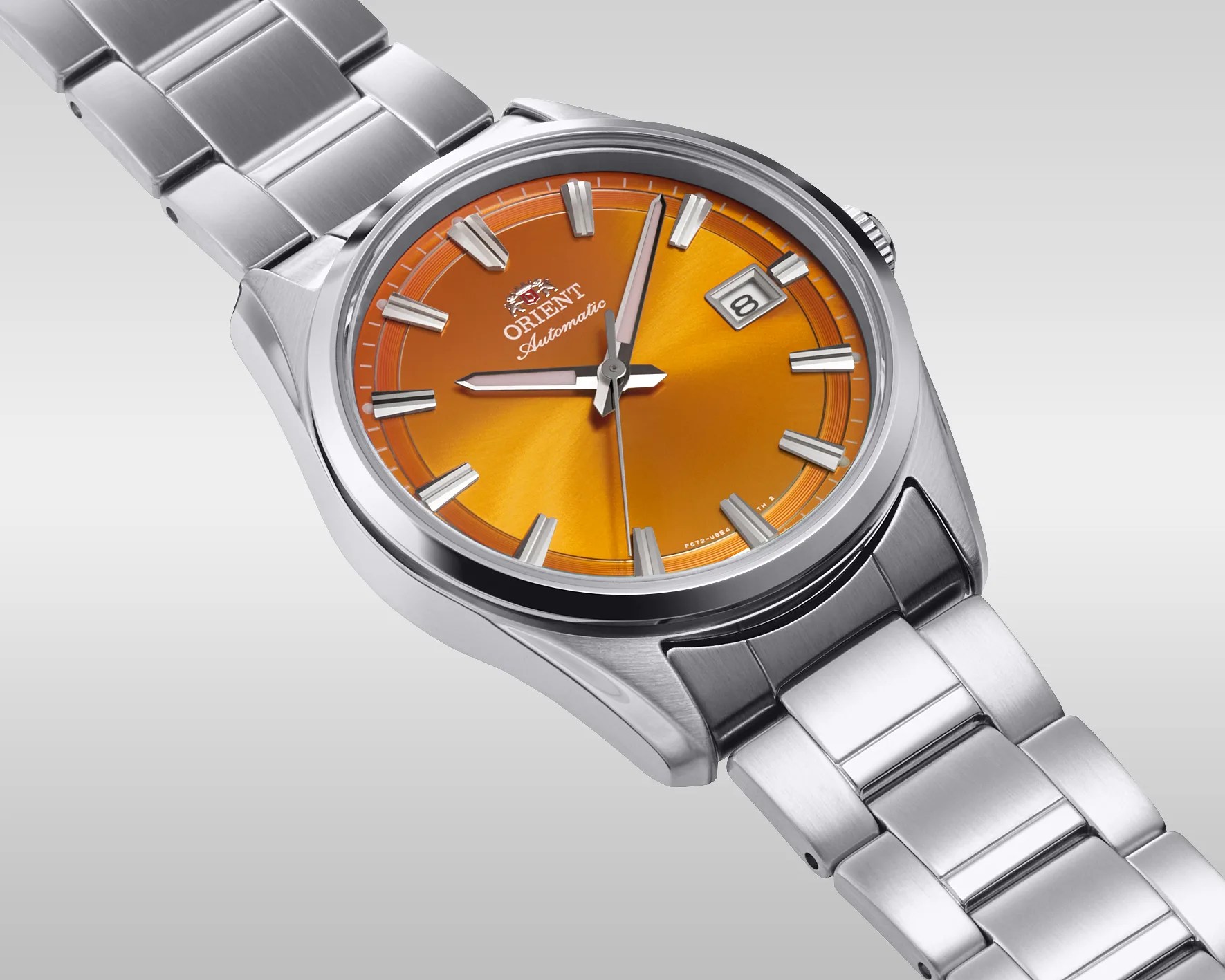 Stainless steel Orient automatic wristwatch with bright orange dial and date window at 3 o'clock.