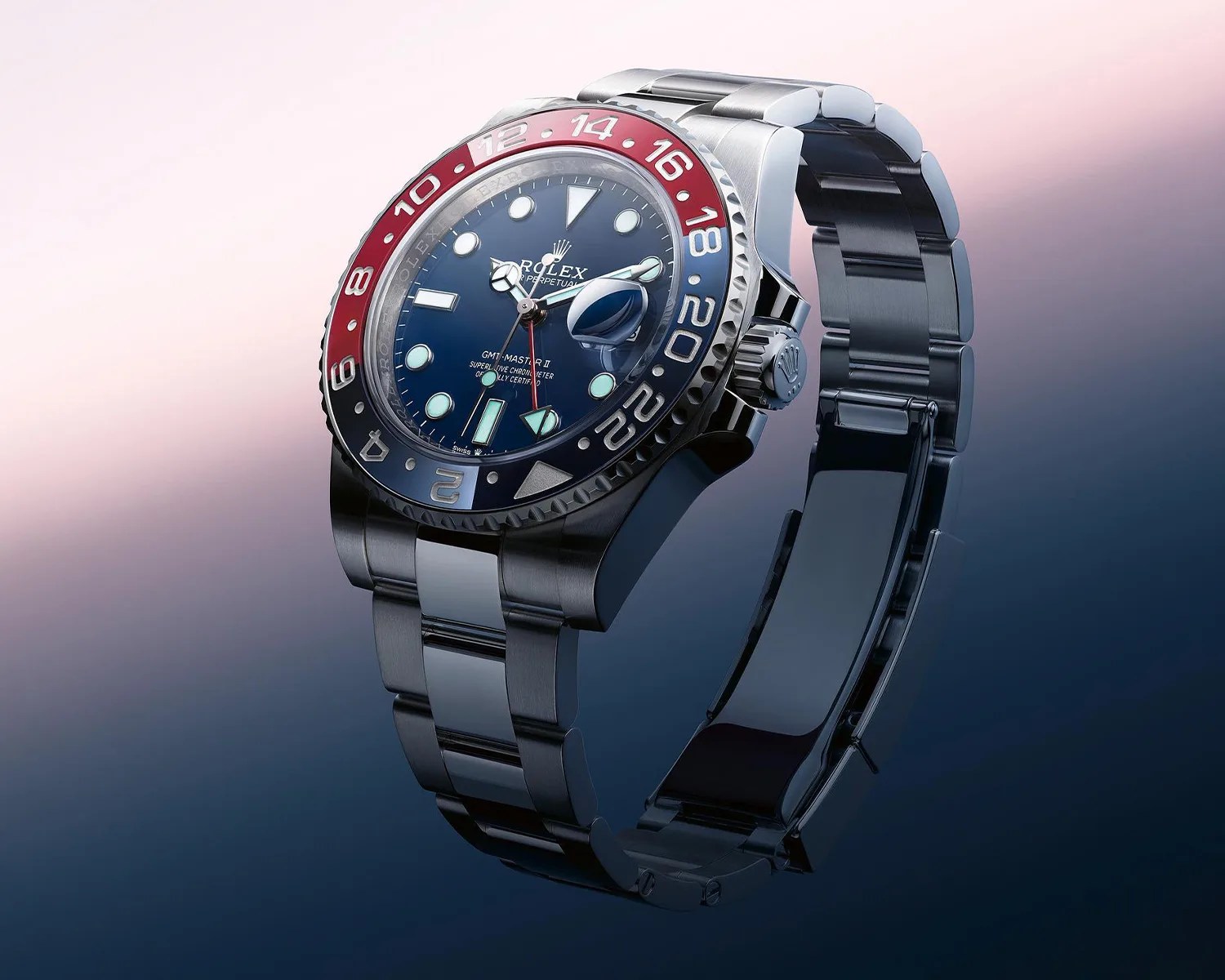 Stainless steel Rolex GMT-Master II watch with blue and red bezel and blue dial.