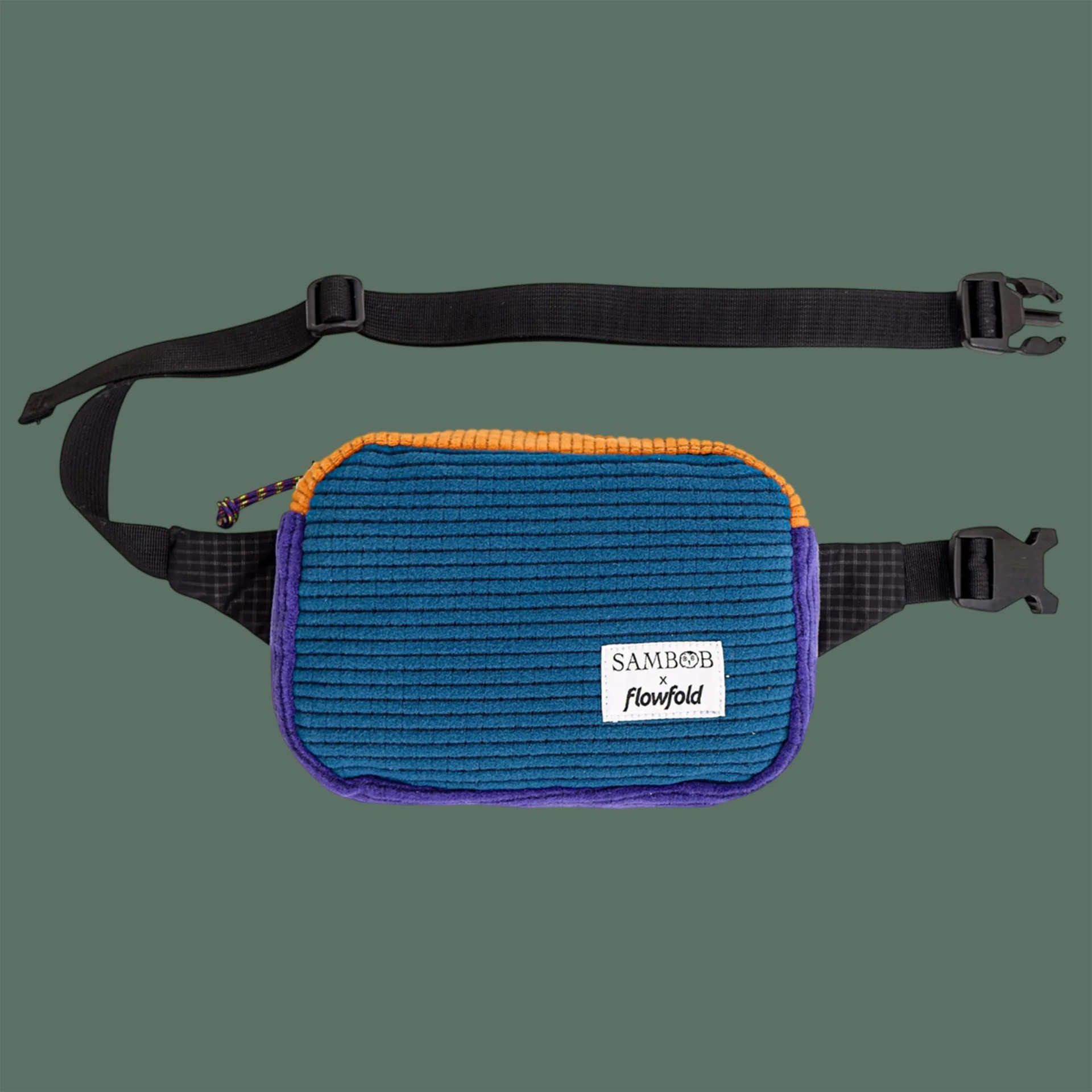 Blue corduroy waist bag with orange and purple trim and black adjustable strap with plastic buckle.