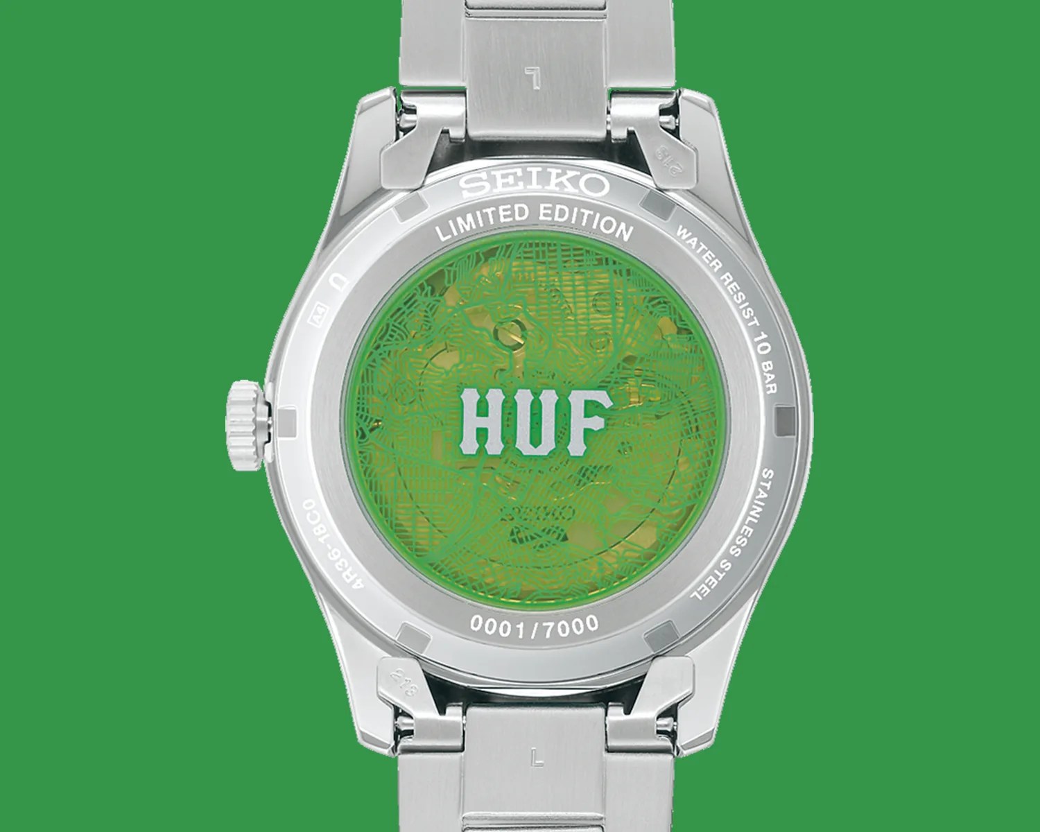 Back of a limited edition Seiko stainless steel watch with green patterned case back and "HUF" logo.