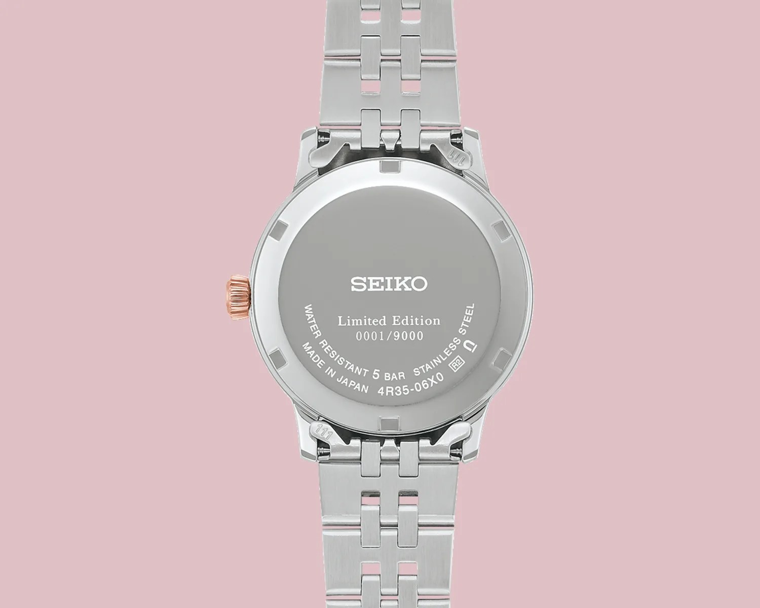 Back of a silver Seiko limited edition wristwatch with stainless steel bracelet and rose gold crown.