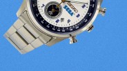 Silver Seiko wristwatch with white dial, blue accents, and SEGA logo on a blue background.