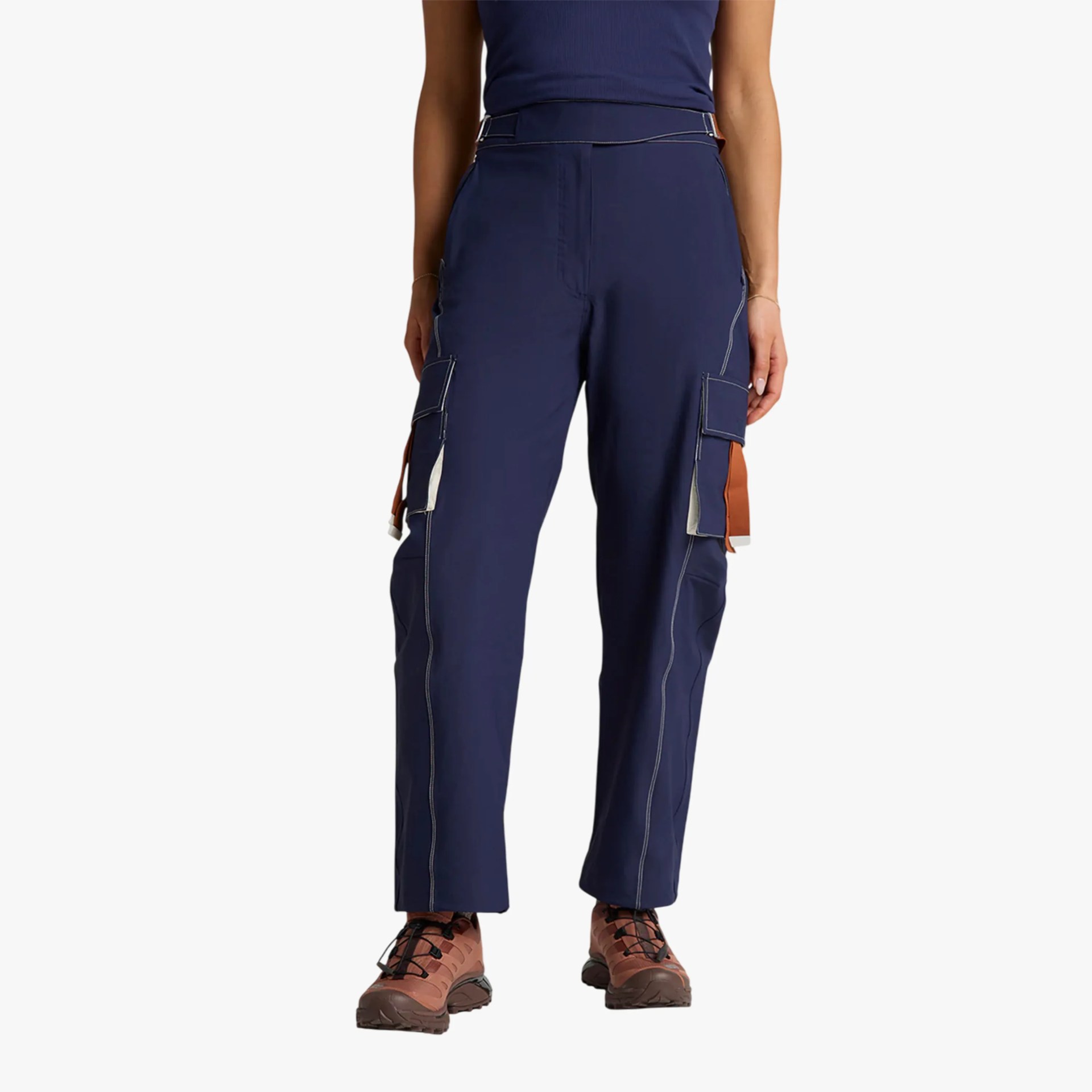 Navy blue cargo pants with white and brown pocket accents worn with brown hiking boots.