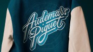 Teal and beige jacket with large "Audemars Piguet" script logo on the back.