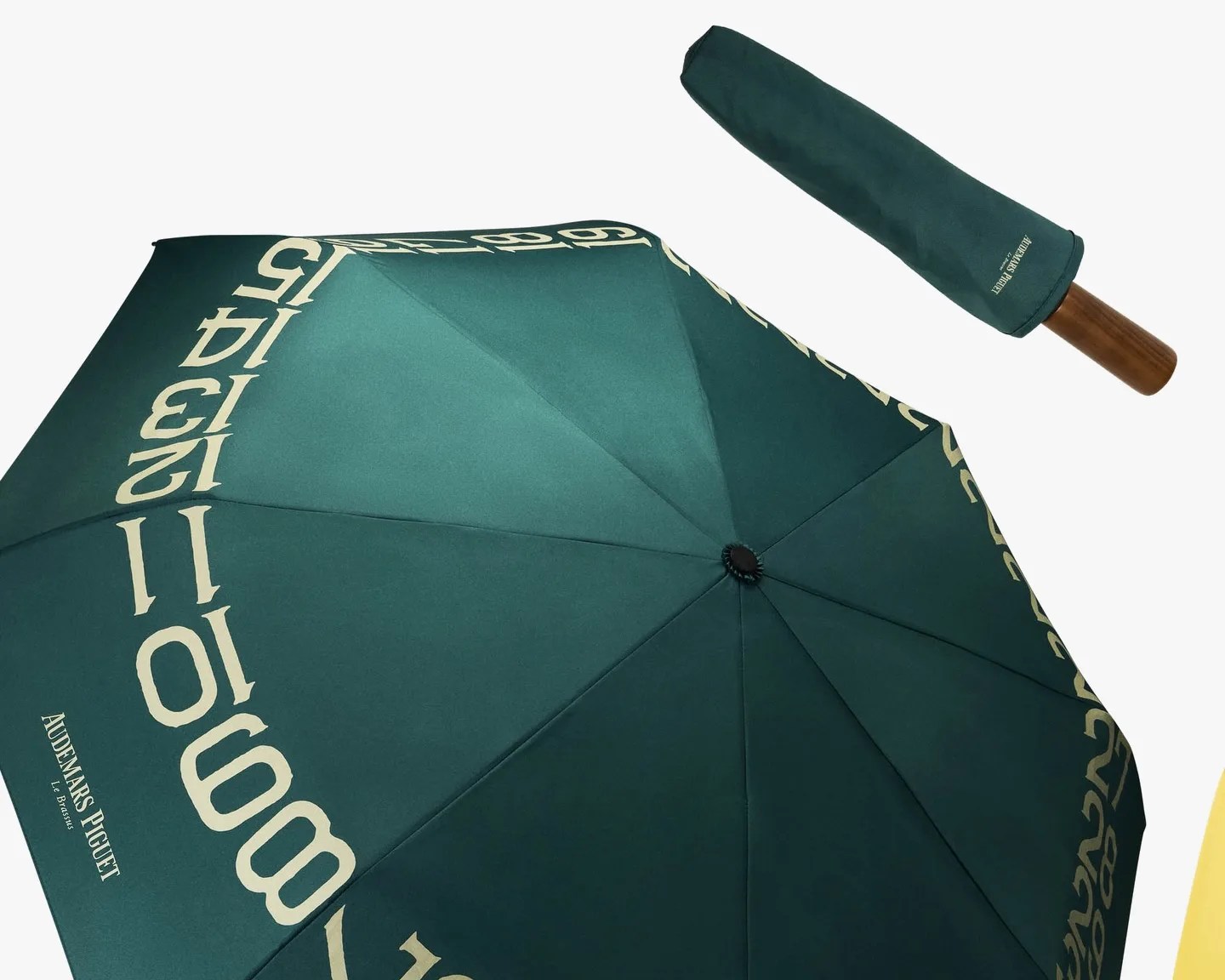 Dark green umbrella with cream numbers around the edge and a wooden handle, shown open and closed with a matching cover.