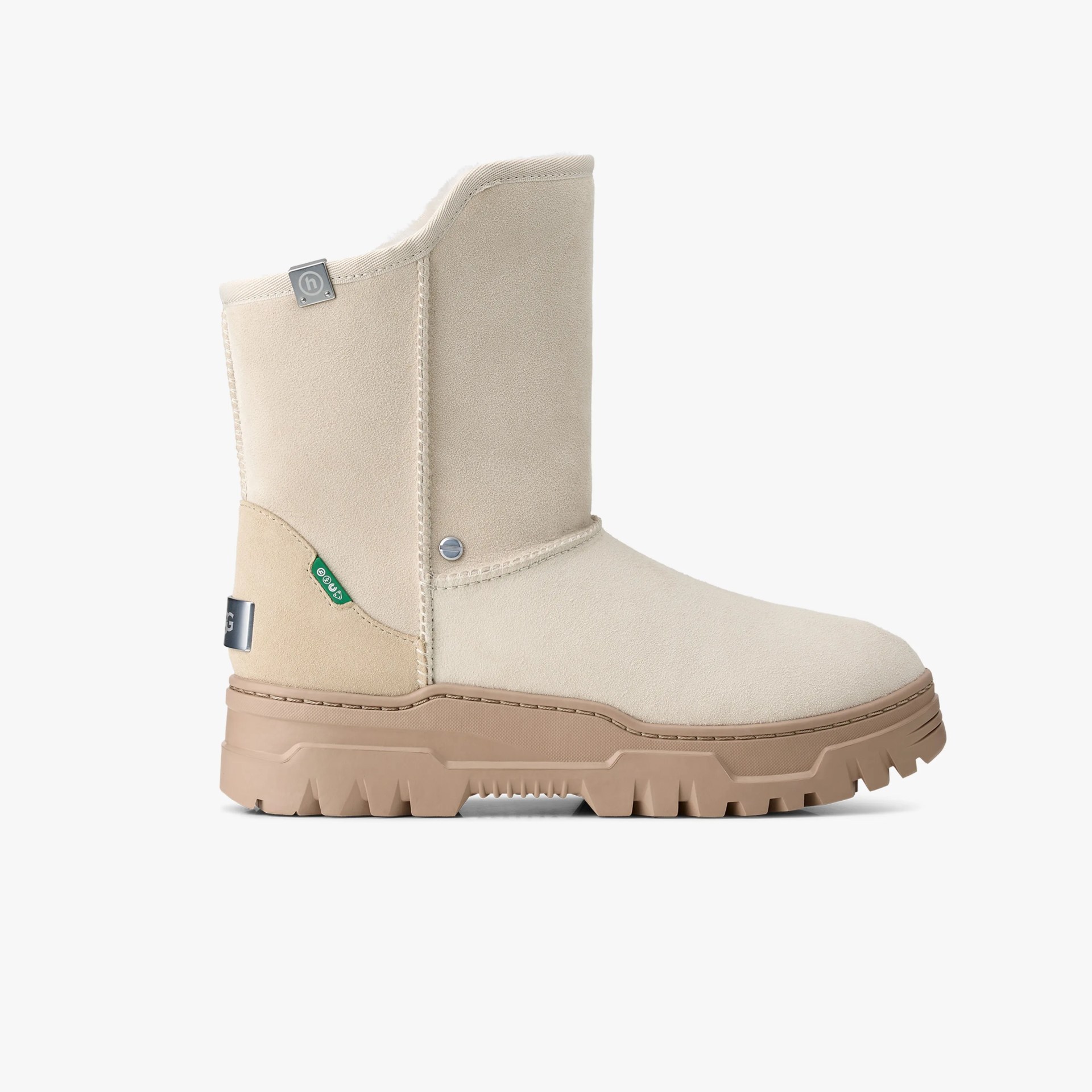 Beige suede mid-calf boot with tan chunky rubber sole and small metal and fabric logo tags.