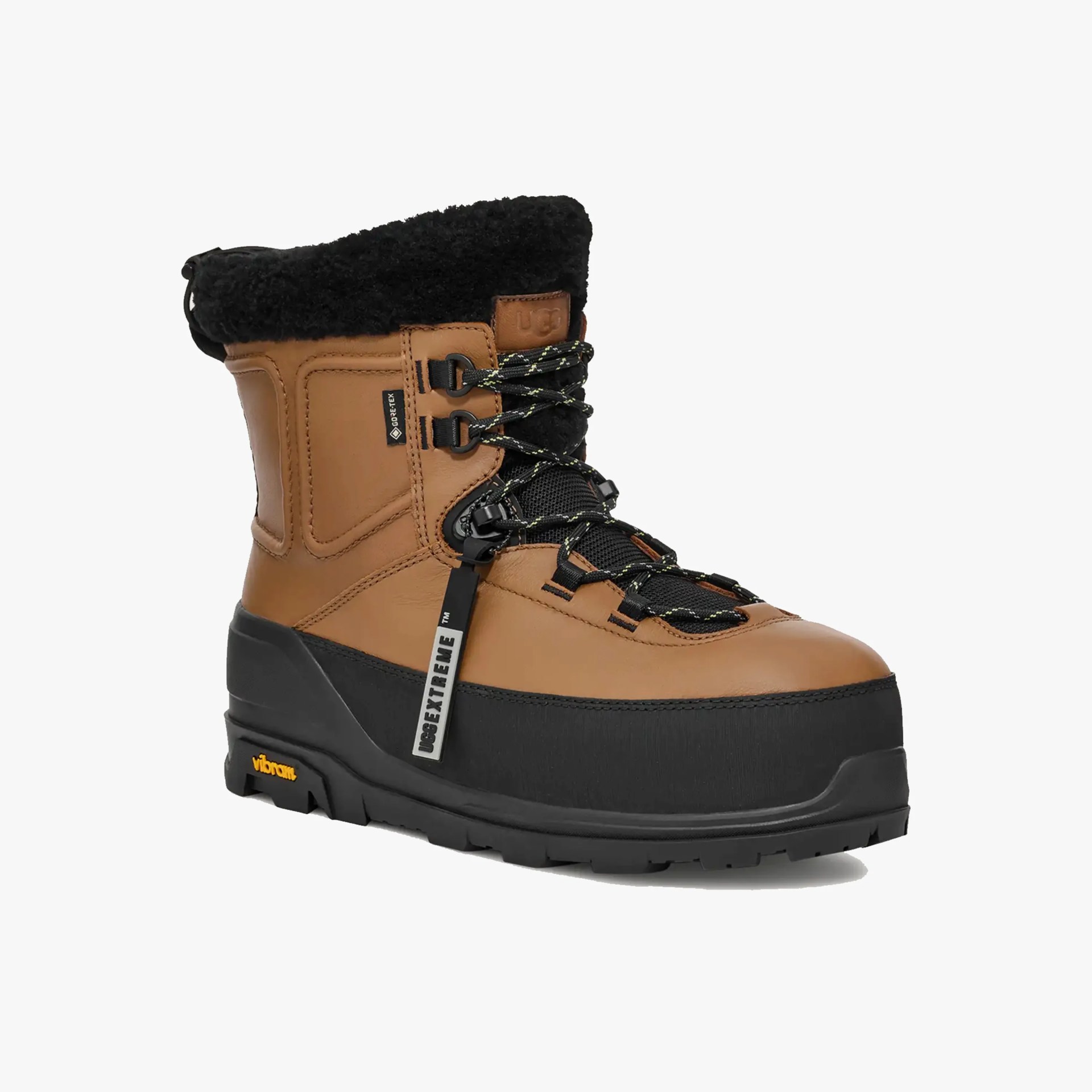Brown and black insulated winter boot with black fur cuff and Vibram sole.