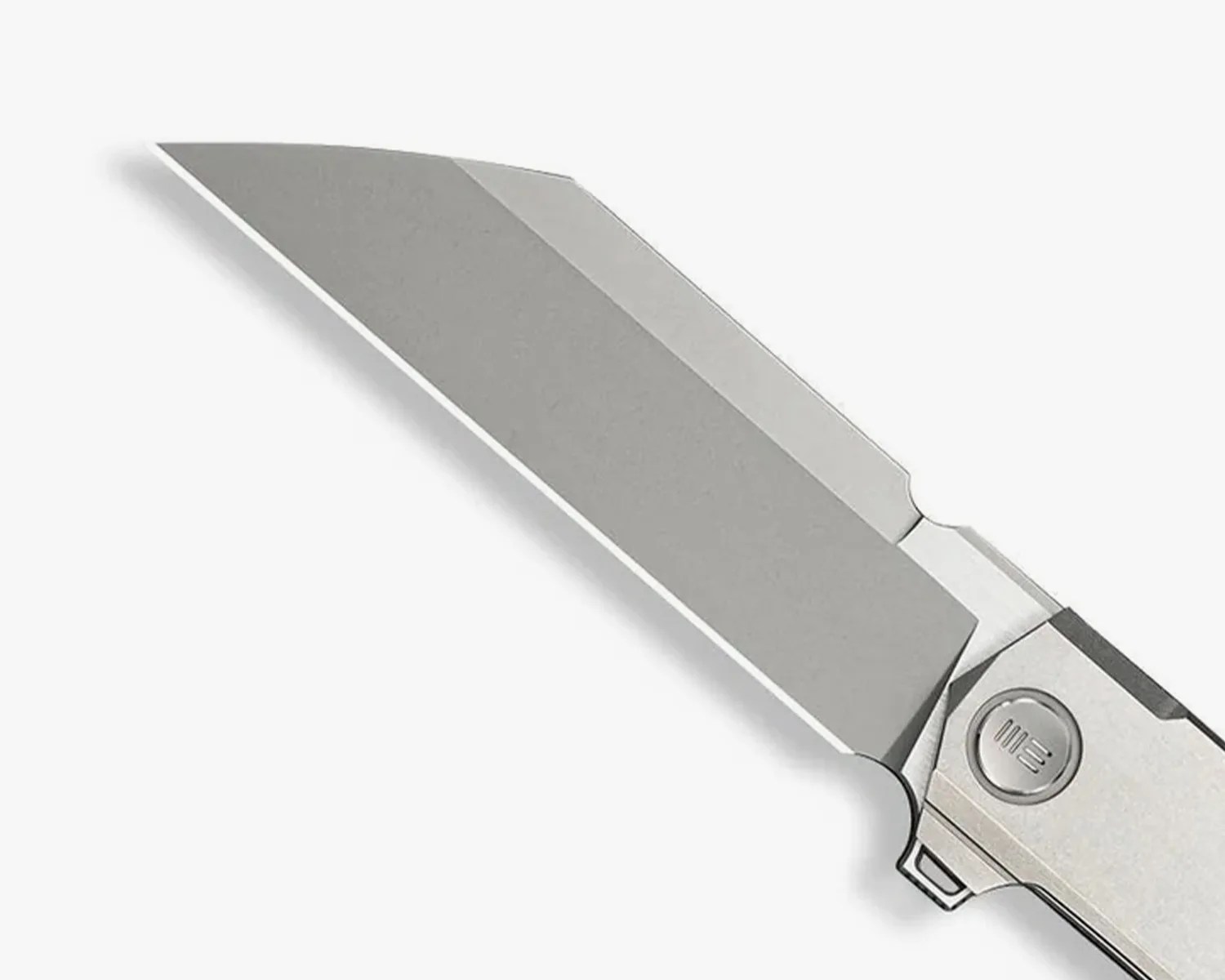 Close-up of a silver tanto-style folding knife blade with a stonewashed finish and a circular pivot screw.