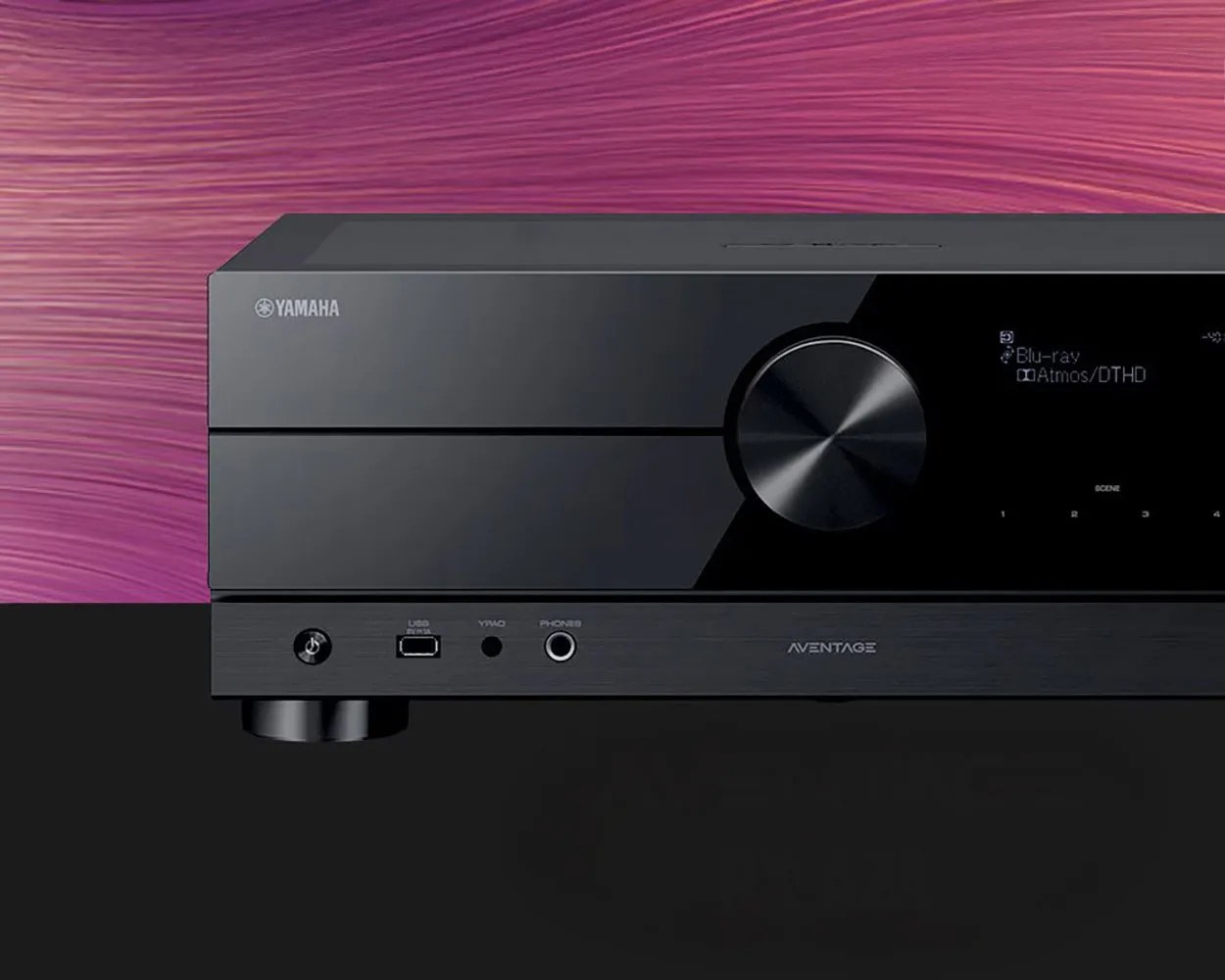 Black Yamaha Aventage AV receiver with volume knob and digital display showing Blu-ray and Atmos/DTHD.