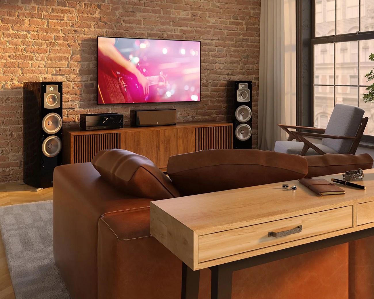 Modern living room with a wall-mounted flat-screen TV, wooden media console, black floor speakers, brown leather sofa, and light wood console table.