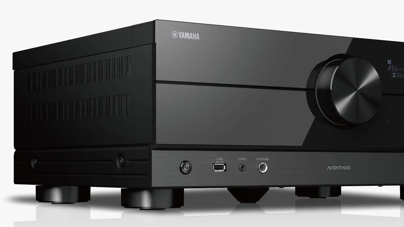 Black Yamaha Aventage audio receiver with volume knob, power button, USB port, and headphone jack.