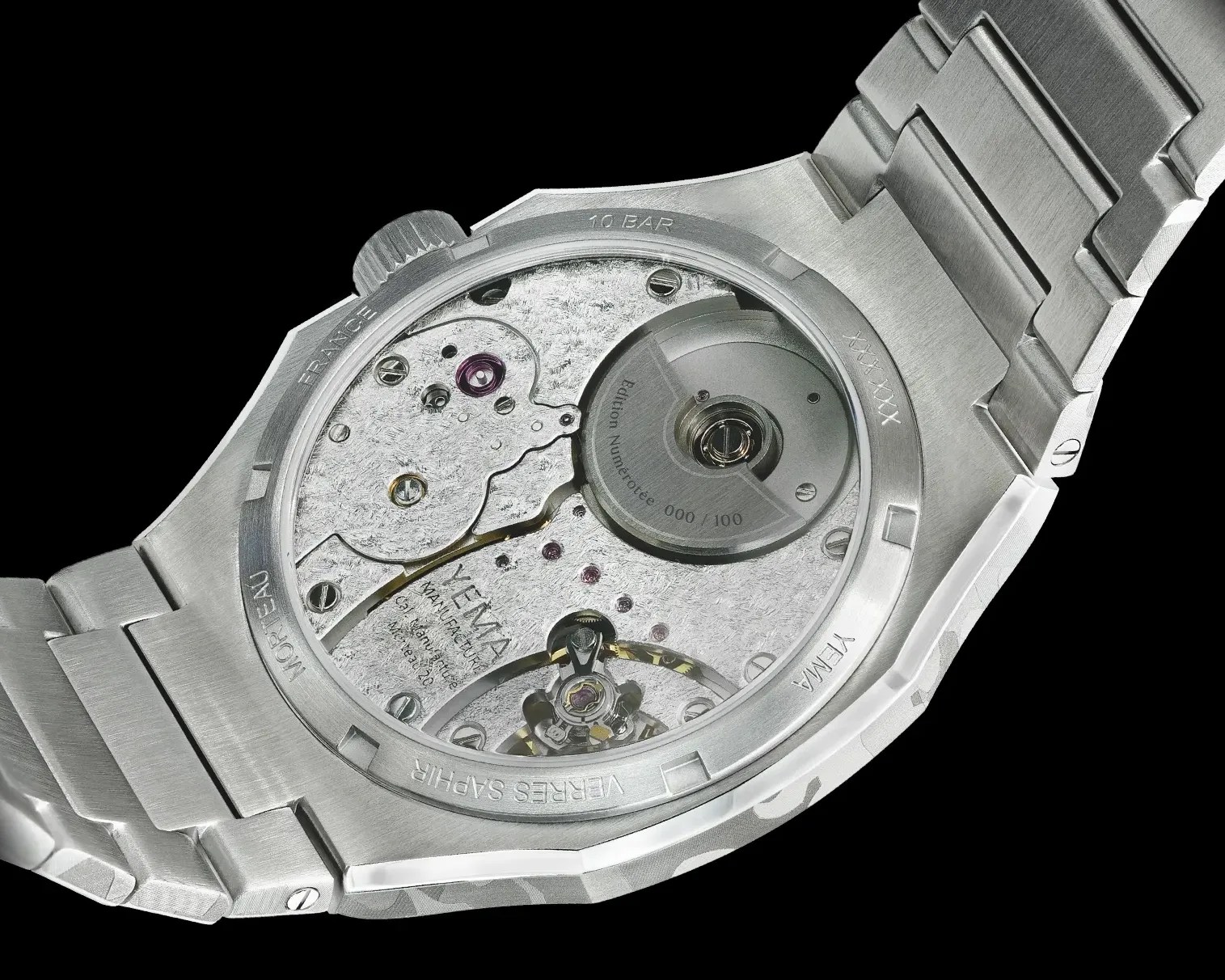 Close-up of a stainless steel watch back showing the mechanical movement and engraved details on the case.