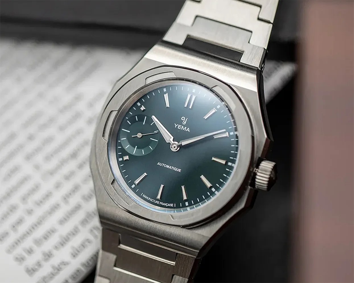 Stainless steel Yema wristwatch with blue dial, silver hour markers, and a small seconds subdial.