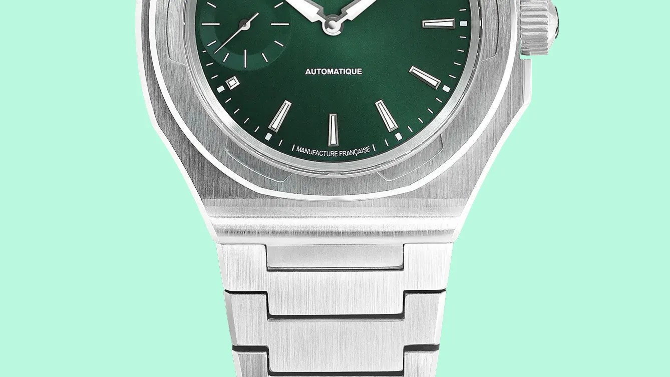 Close-up of a stainless steel watch with a green dial and brushed metal bracelet.
