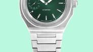 Close-up of a stainless steel watch with a green dial and brushed metal bracelet.