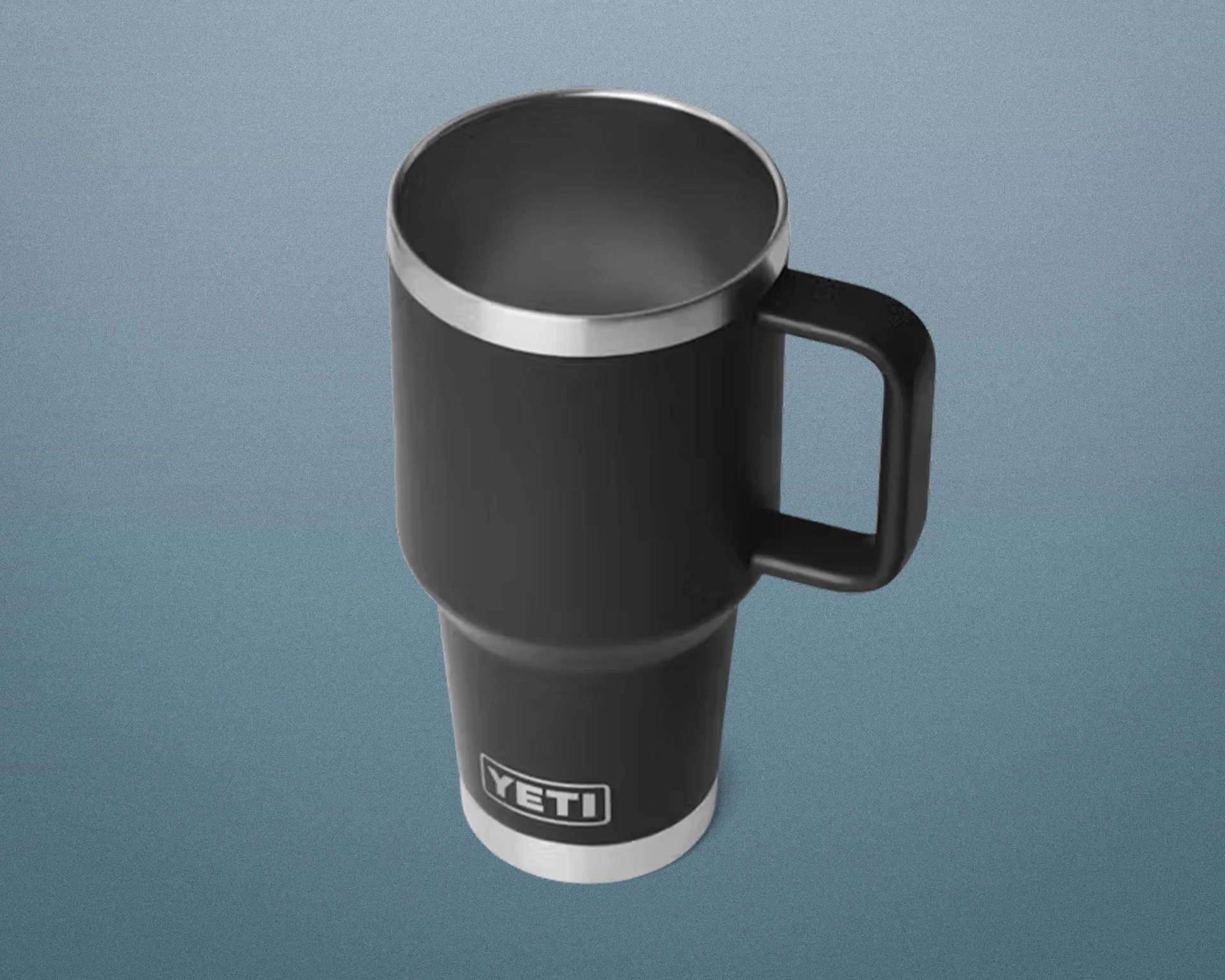 Black YETI insulated travel mug with handle and stainless steel rim on a blue-gray background.