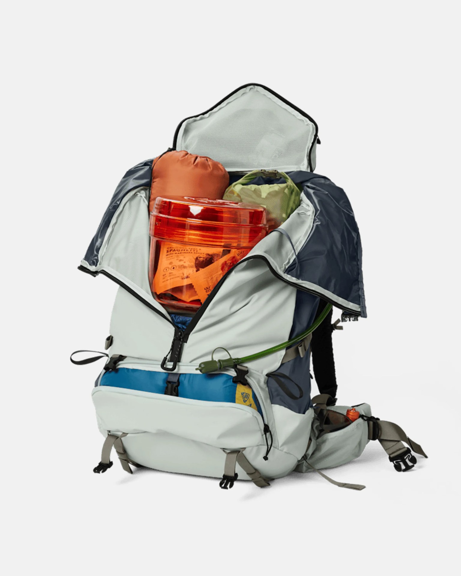 Light gray and navy hiking backpack with multiple compartments open, containing camping gear and an orange container.