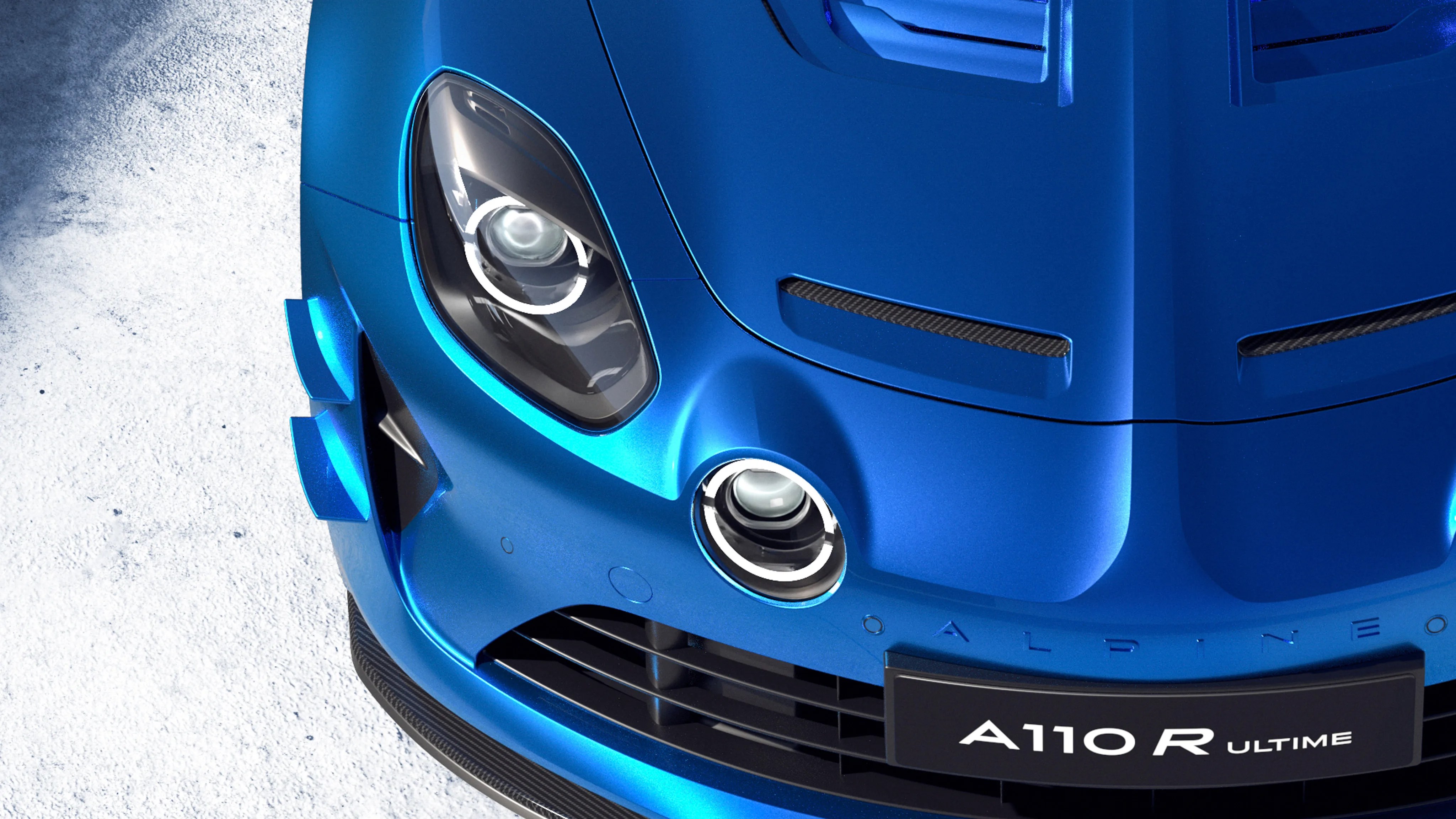 Close-up of the front end of a blue Alpine A110 R Ultime sports car showing headlights and grille.