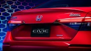 Rear view of a red 2025 Honda Civic Hybrid Sport Touring with illuminated taillights and hexagonal blue background.