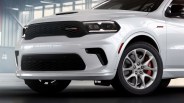 Front side view of a white Dodge SUV with black grille, red brake calipers, and 392 badge on the fender.