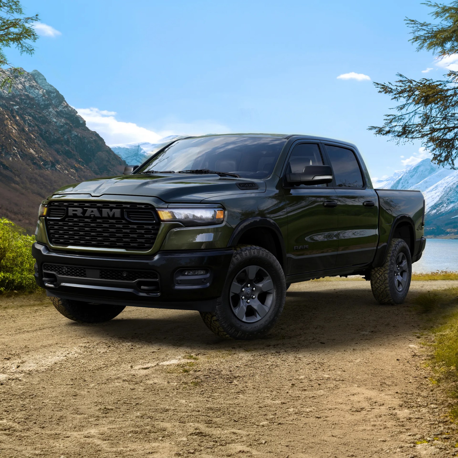 Dark green RAM 1500 pickup truck parked on a dirt road with mountains and a lake in the background.