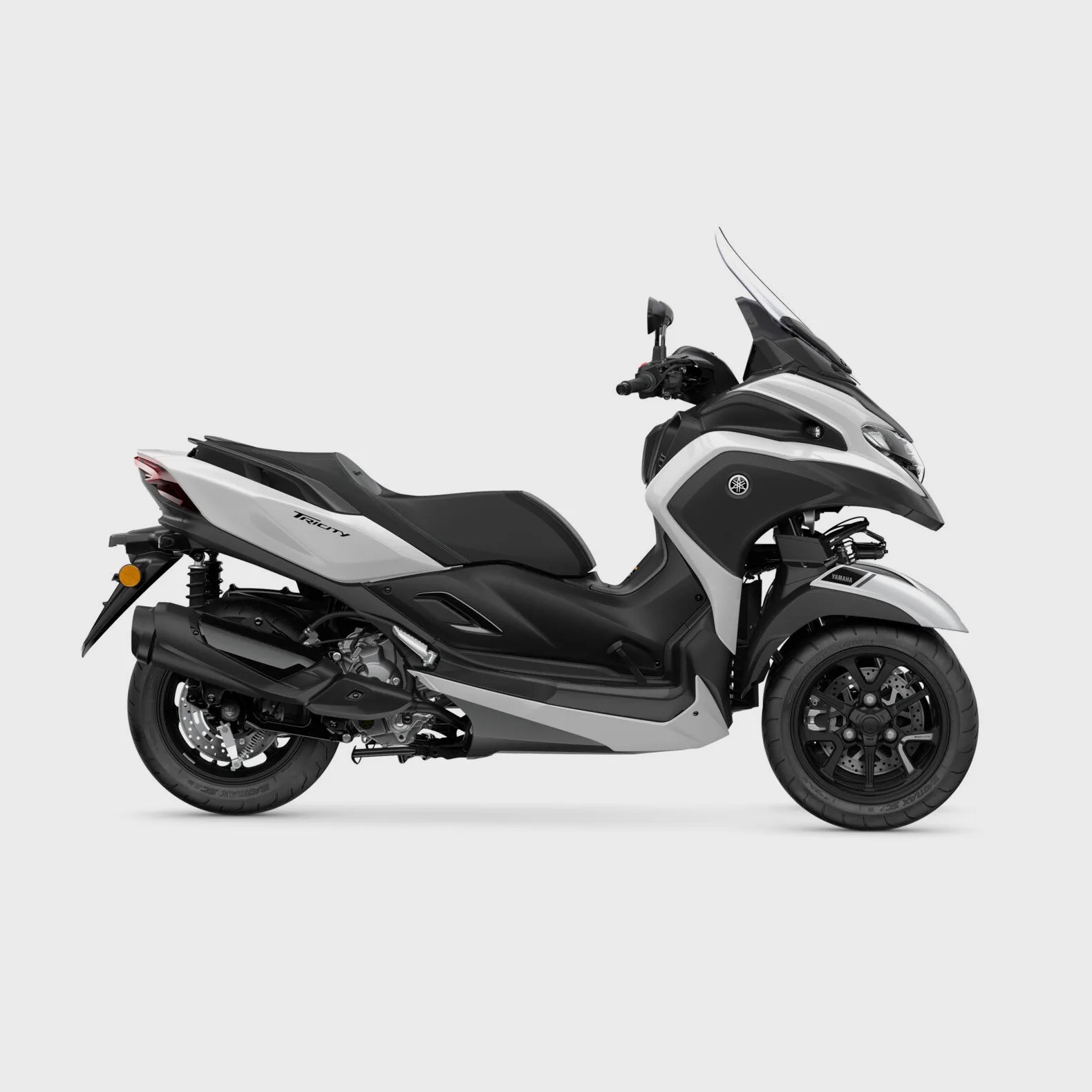 White and black Yamaha Tricity three-wheeled scooter with windshield on a white background.