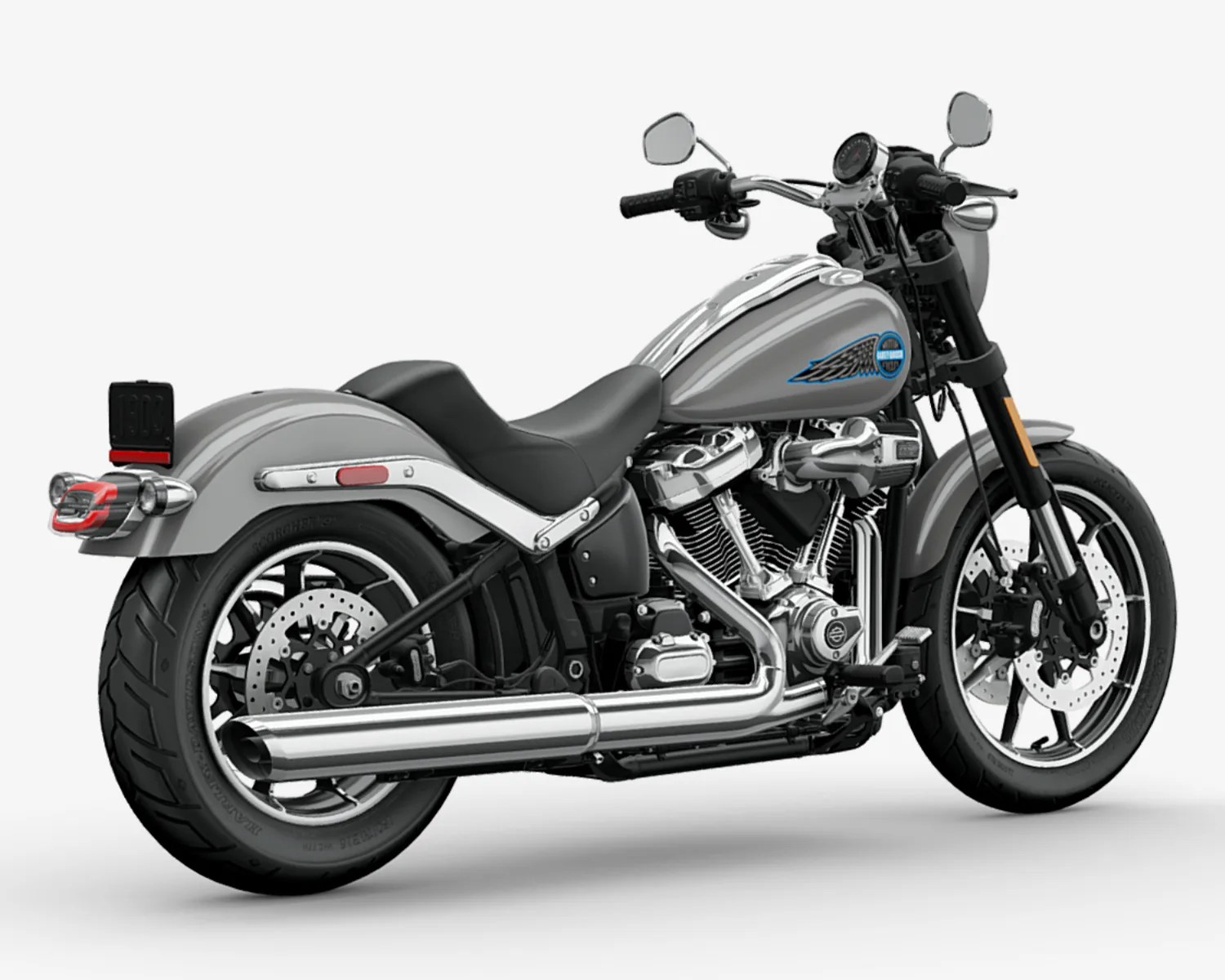 Silver Harley-Davidson motorcycle with black seat and chrome exhaust pipes on a white background.