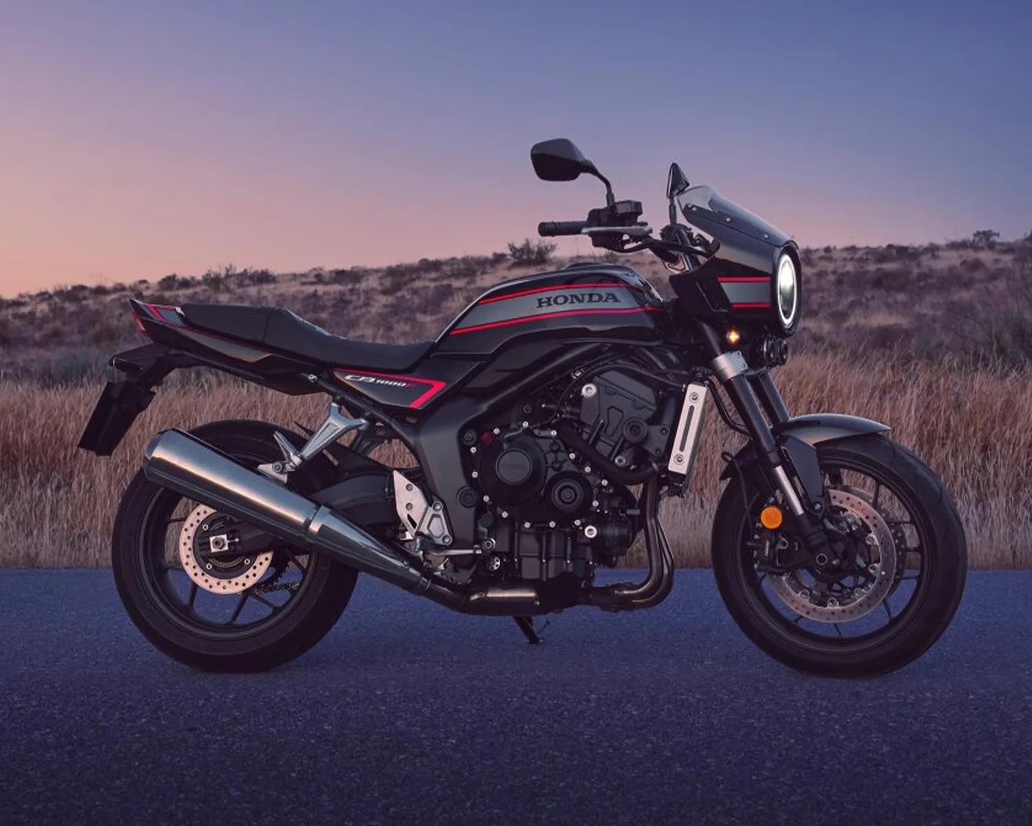 Black and gray Honda CB1000R motorcycle with red accents parked on a road at dusk.