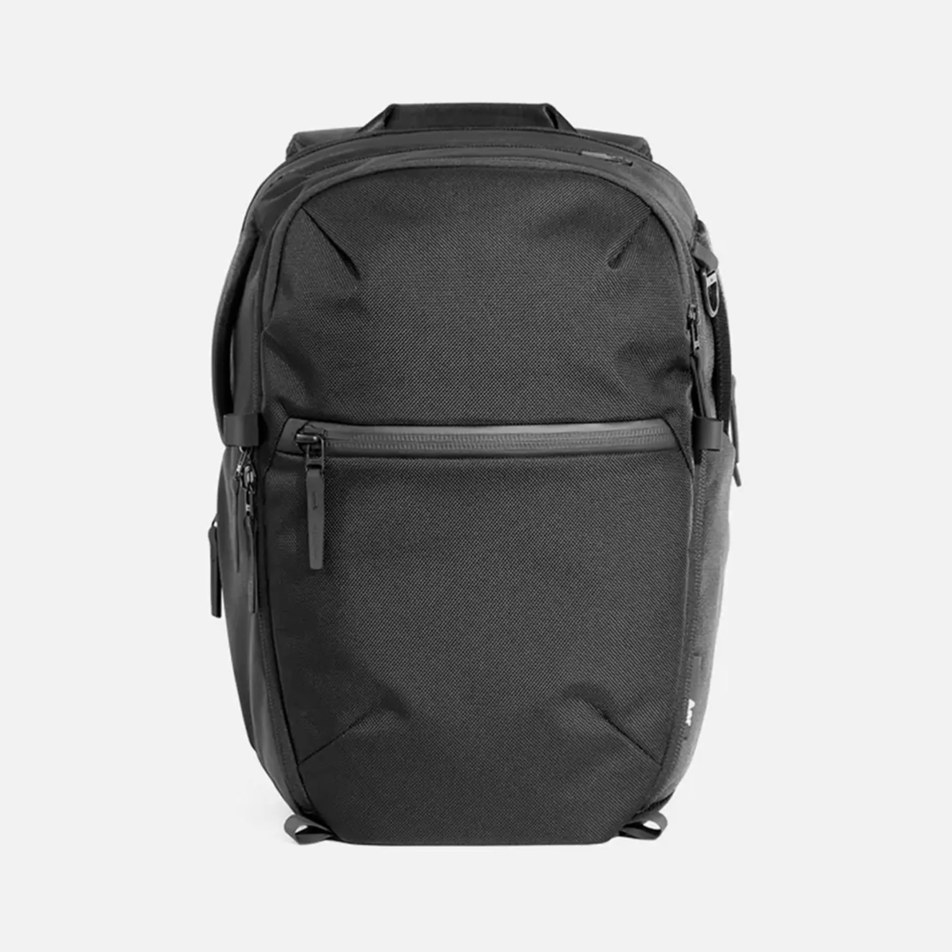 Black rectangular backpack with front zippered pocket and top handle on a white background.