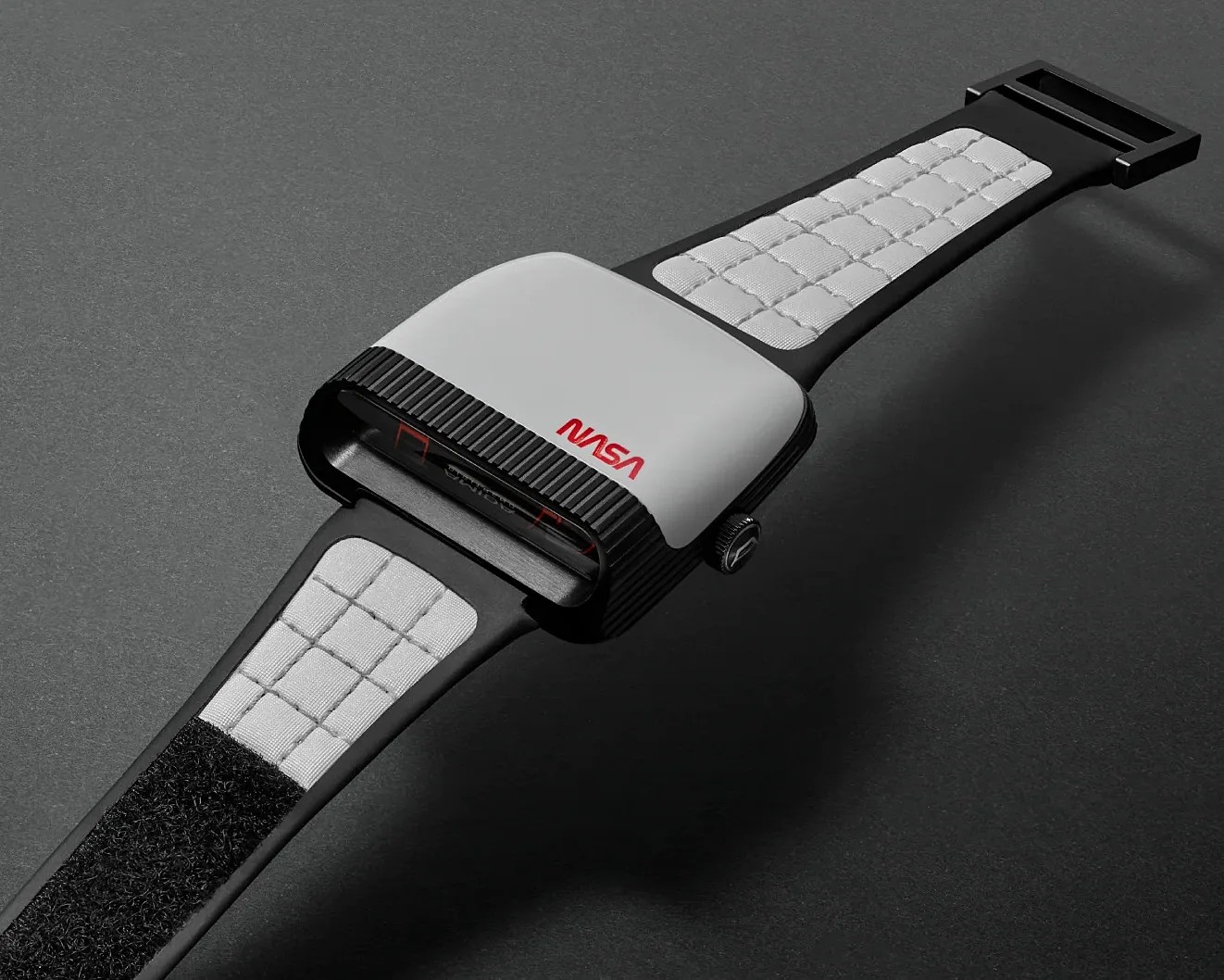 Black and white NASA-branded digital watch with a quilted strap and rectangular face on a dark surface.