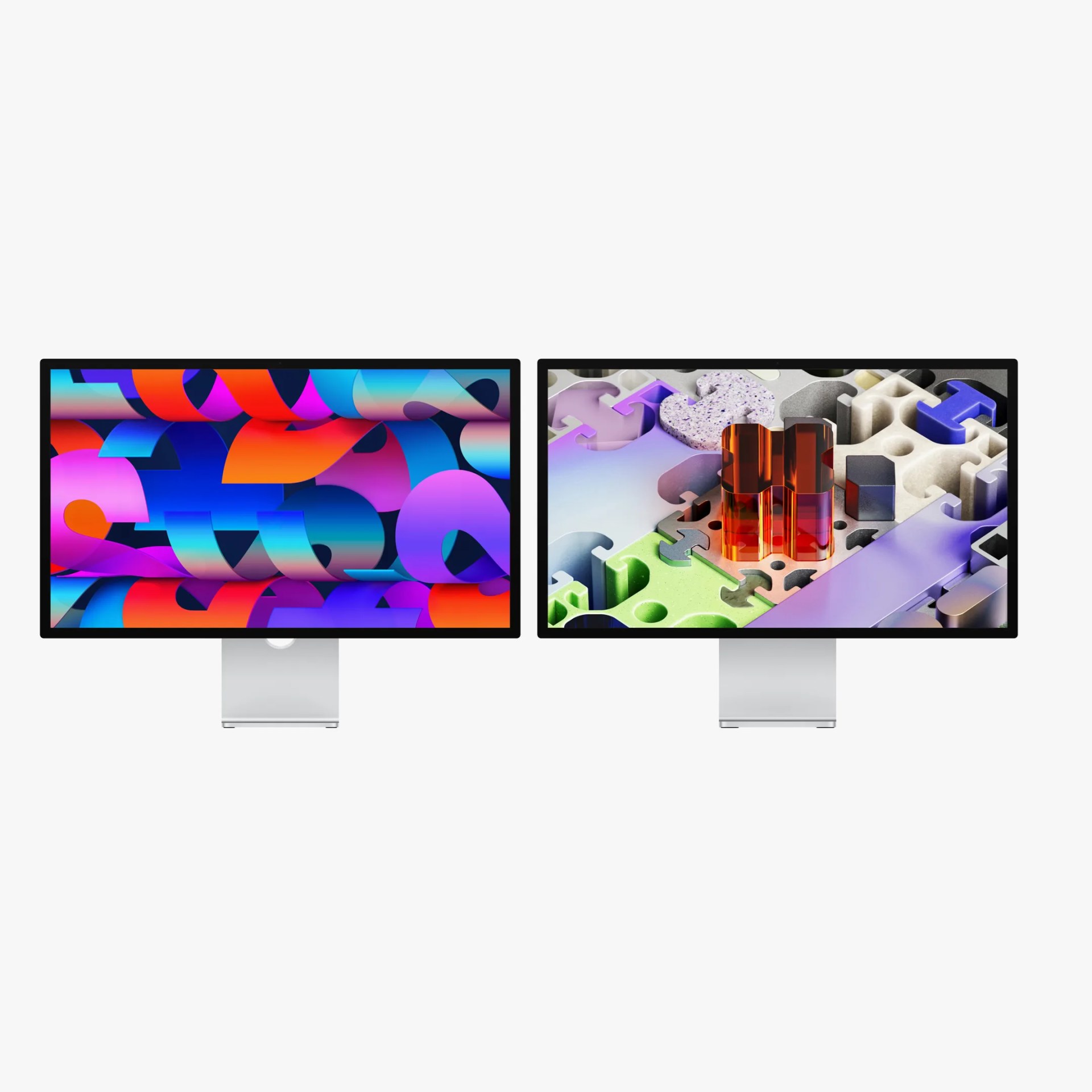 Two sleek, modern computer monitors with thin black bezels and silver stands, displaying colorful abstract digital art.